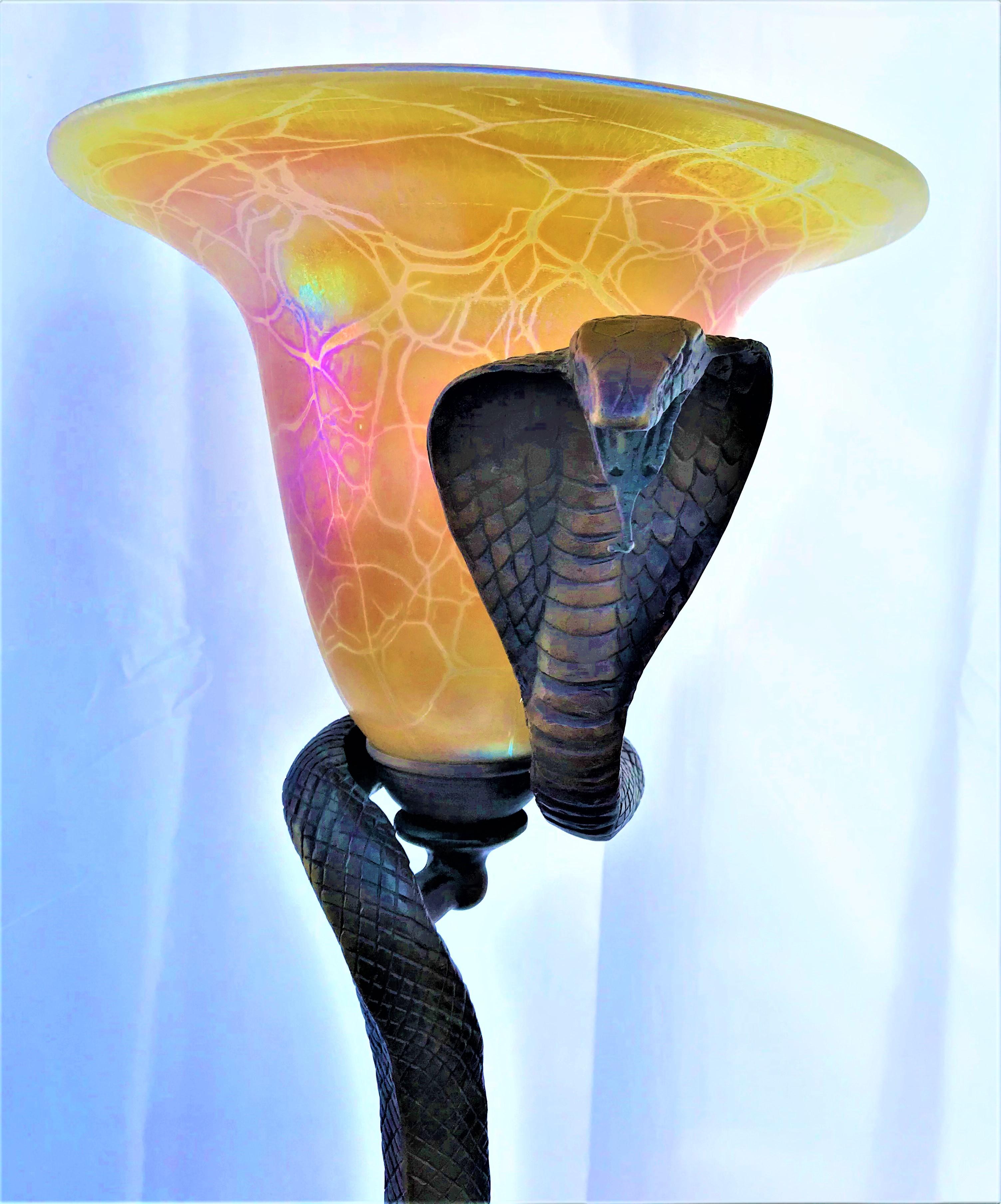 A mid-size Cobra snake floor lamp contemporary bronze lamp. With a gold favrile snake skin design glass shade. Bronze patina finish mounted on an absolute black hi-polished marble base. Made after E. Brandt design. From a private collector in LA.