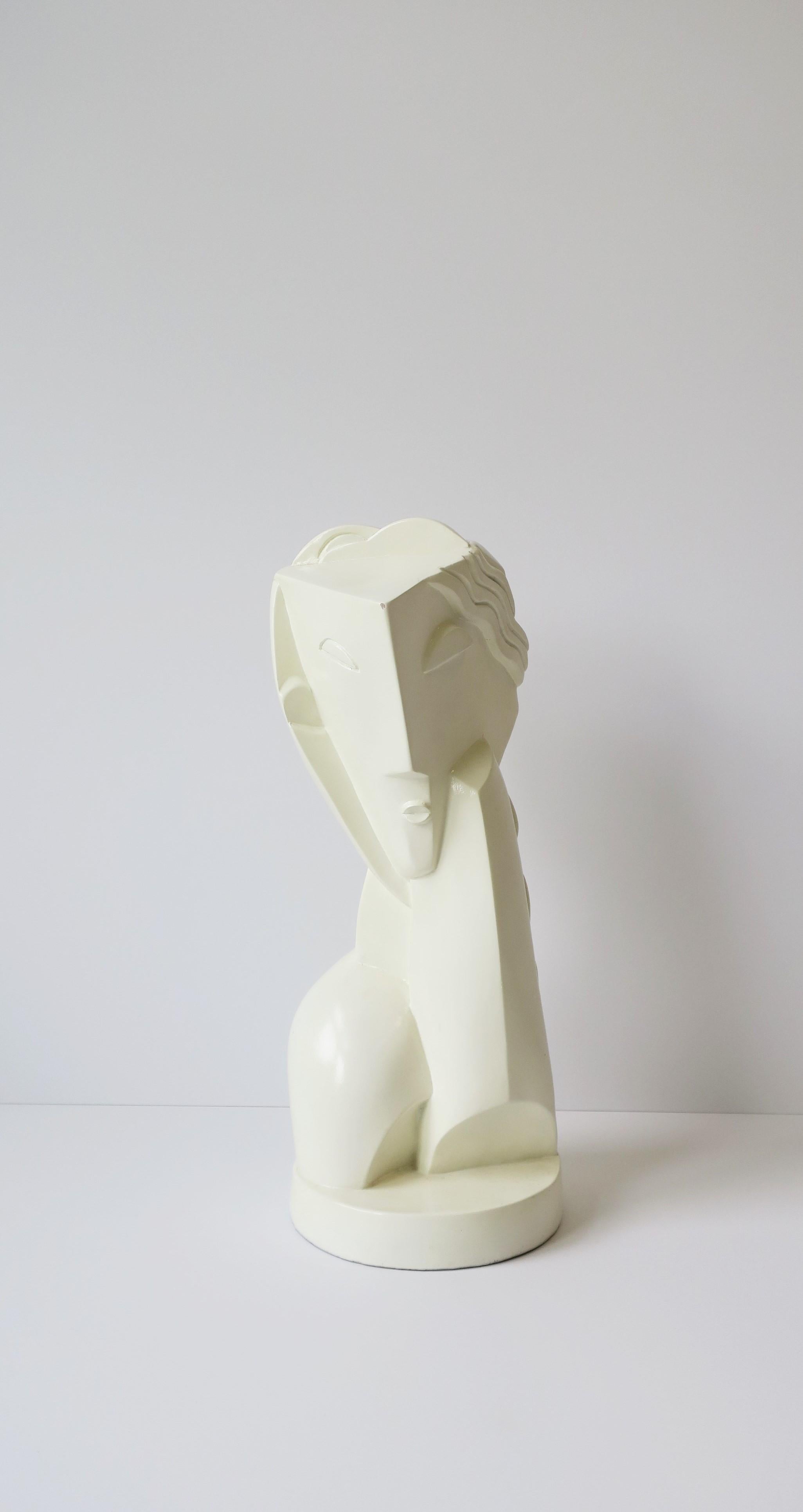 A beautiful Art Deco modern cubist figurative bust sculpture piece, 1961, England. This piece was made in 1961, as marked, a reproduction from the early 20th century Art Deco modern period. Beautiful at every angle. Piece is a gloss ceramic in an