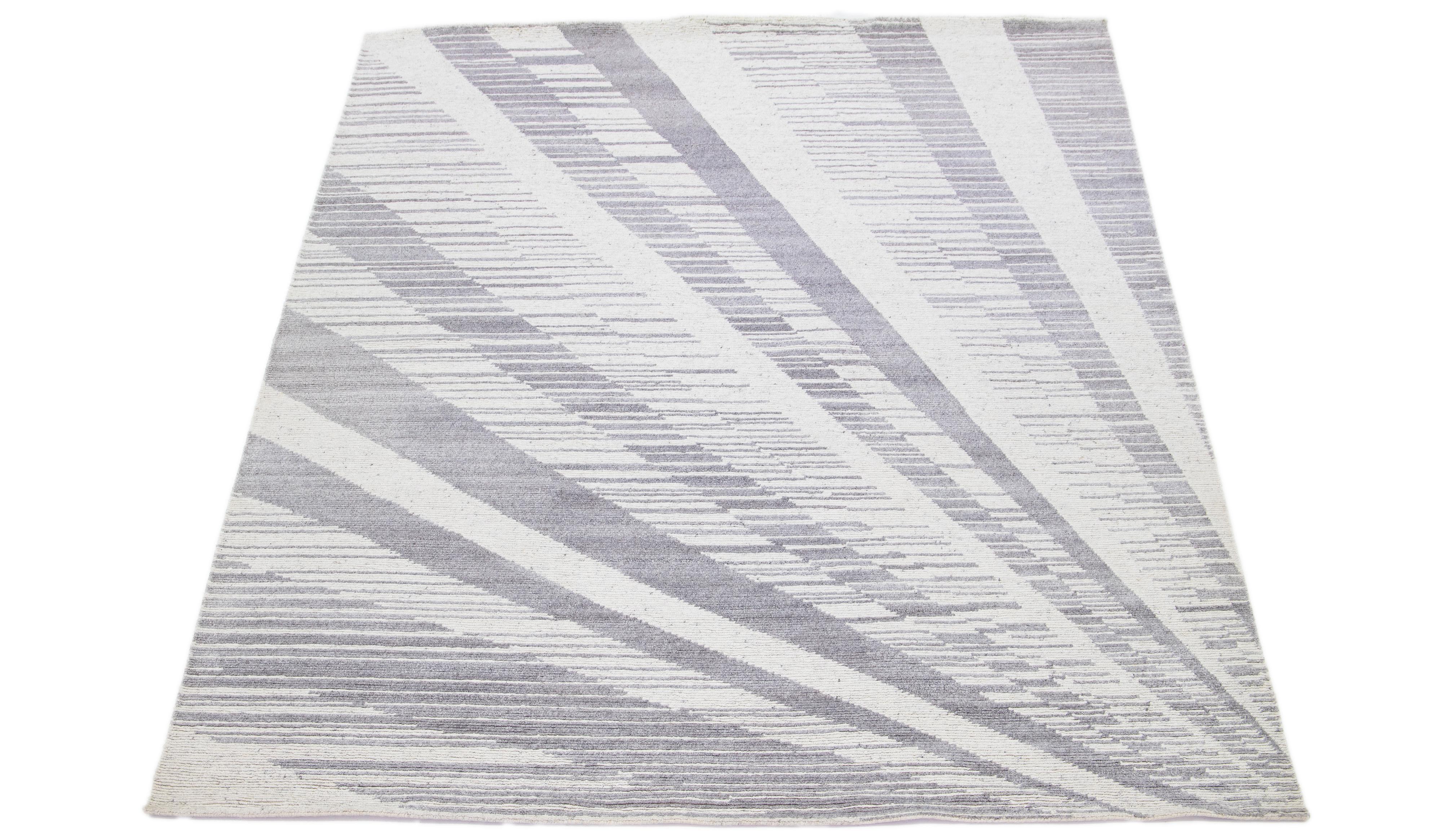 This modern wool rug showcases an abstract gray field with decorative ivory. The all-over design exemplifies the spirit of modernism in the 21st century, making it a truly sophisticated and fashionable addition to any interior setting.

This rug