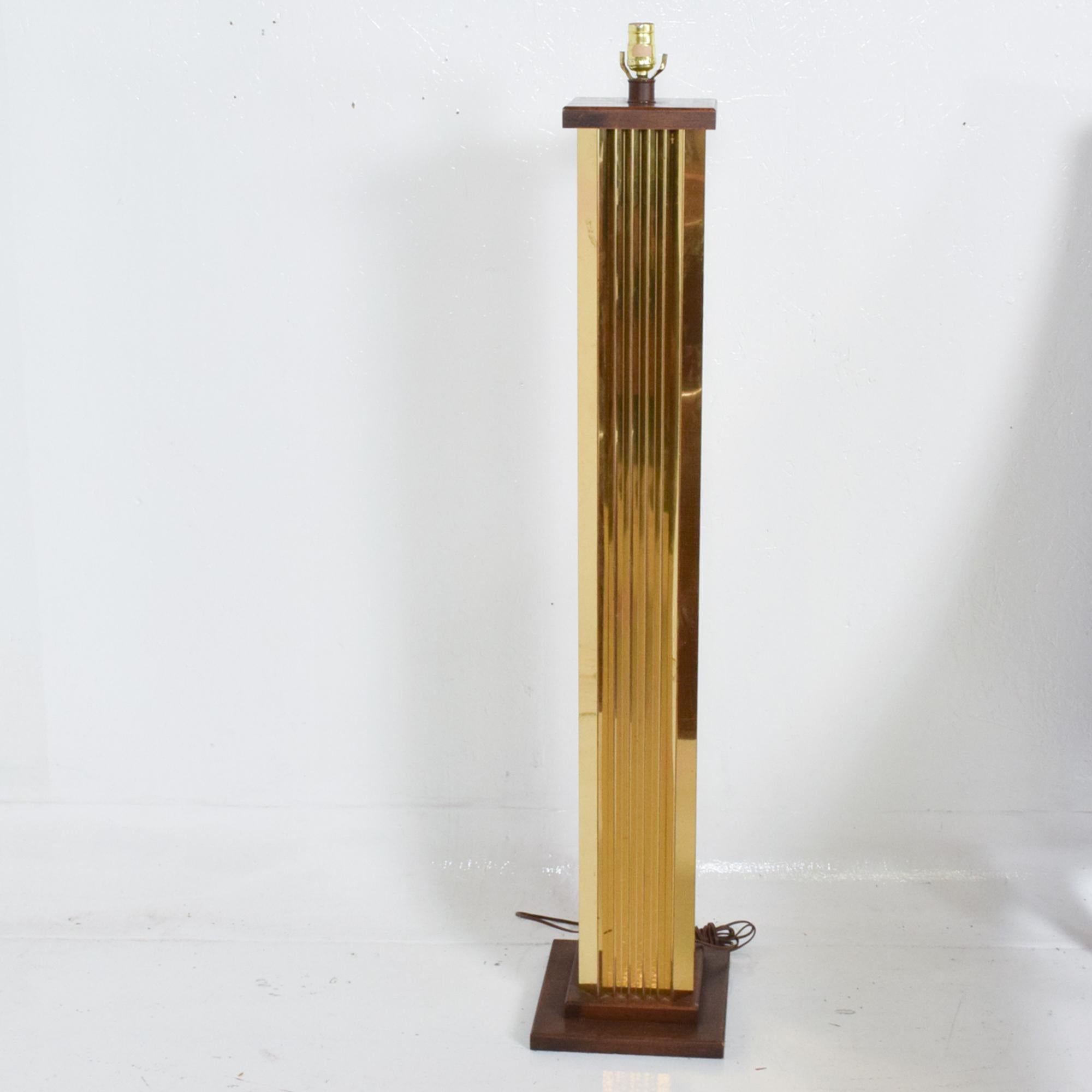 Floor Lamp
Monumental Modern Floor Lamp Extruded Brass Pedestal Shape with Walnut Caps 
Strong influence of Paul Evans Cityscape lines. Art Deco Style statement.
Made in the USA, circa the 1970s.
Walnut Wood base with a brass body.
Dimensions: 52 x