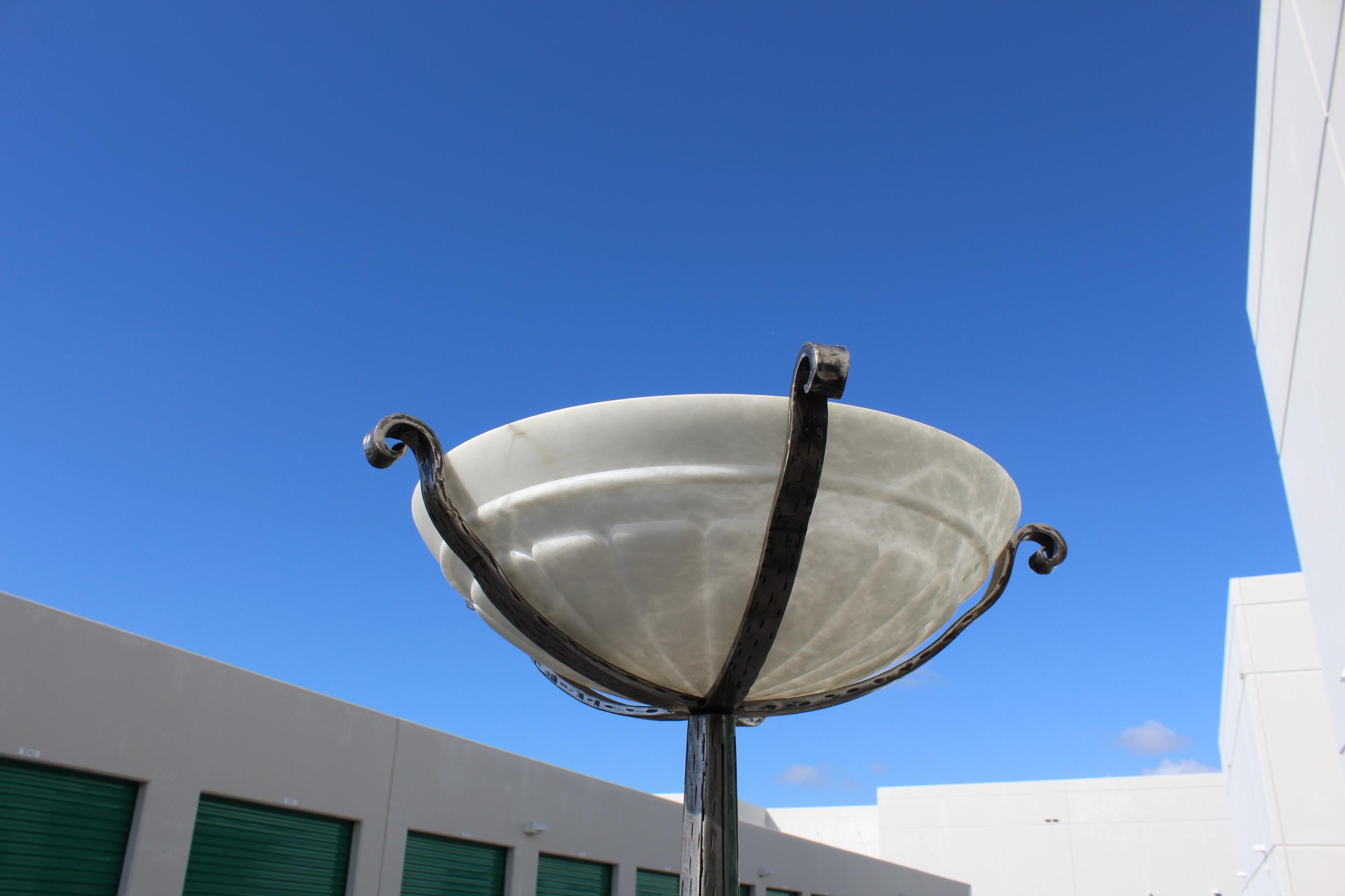 A Custom Designed and hand forged mild steel floor Lamp in the manor of Art Deco . Possibly the style of Paul Kiss . The alabaster shade from Spain is highly carved and with a ring near the top . About 19 1/2