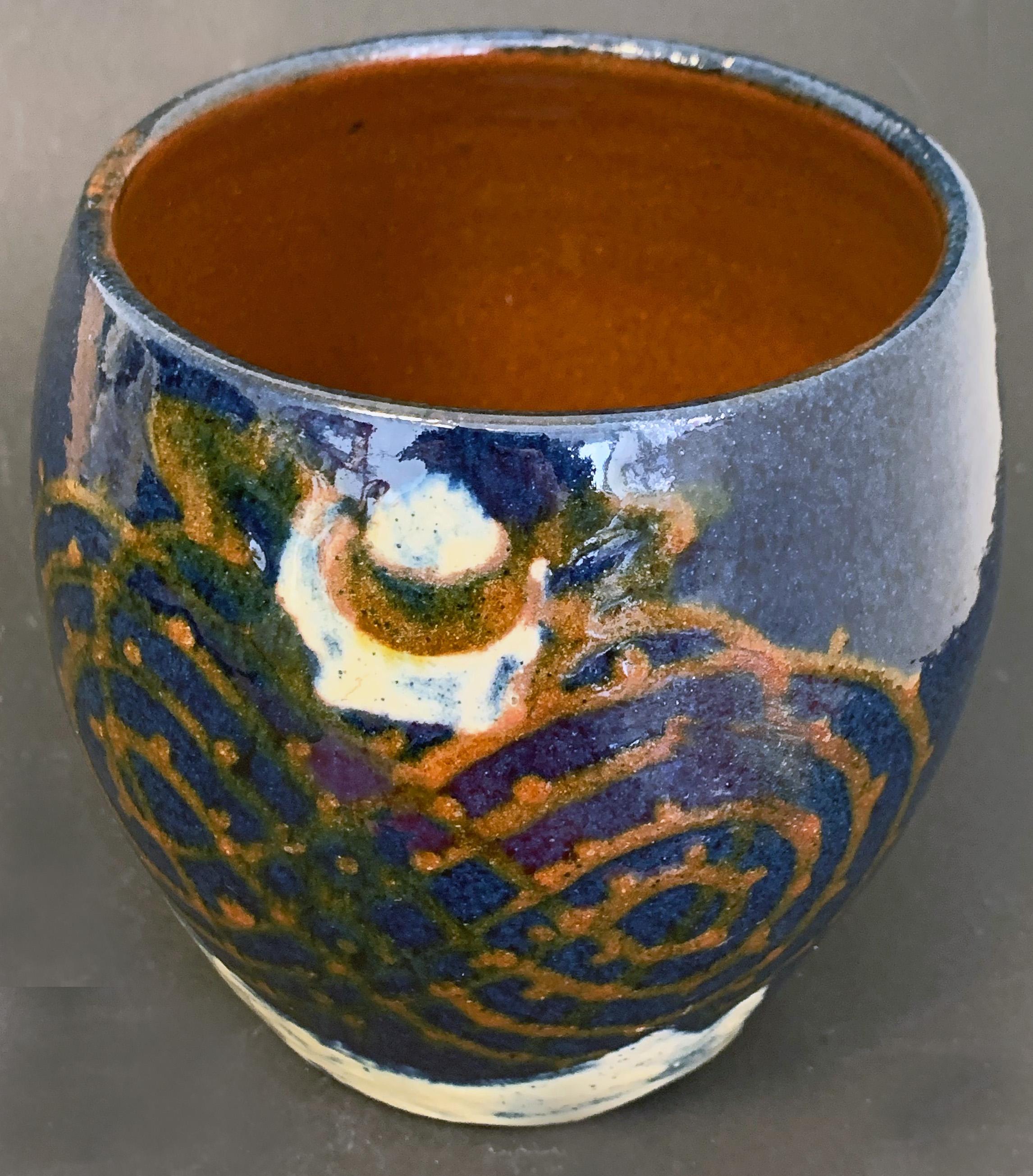 Possibly by the Primavera workshop established by Le Printemps department store in Paris, this marvelous vase is executed in deep blue and orange glazes, with splashes of ivory. Primavera was best known for its Art Deco and Moderne designs, though