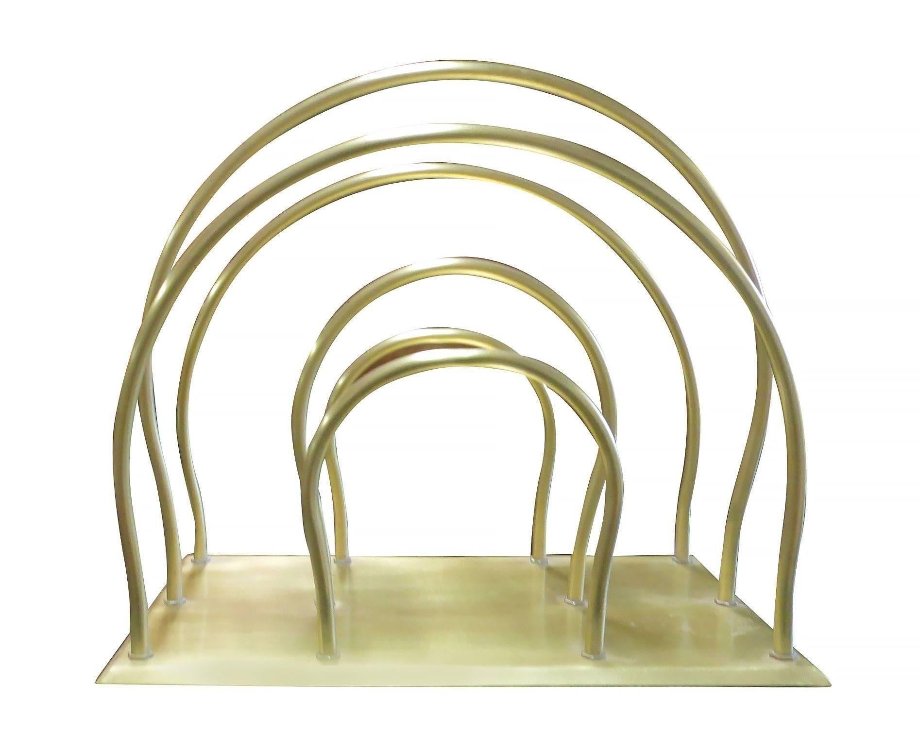 Solid brass Art Moderne magazine rack featuring Streamline style with a square base and three dividers made of six tubular 