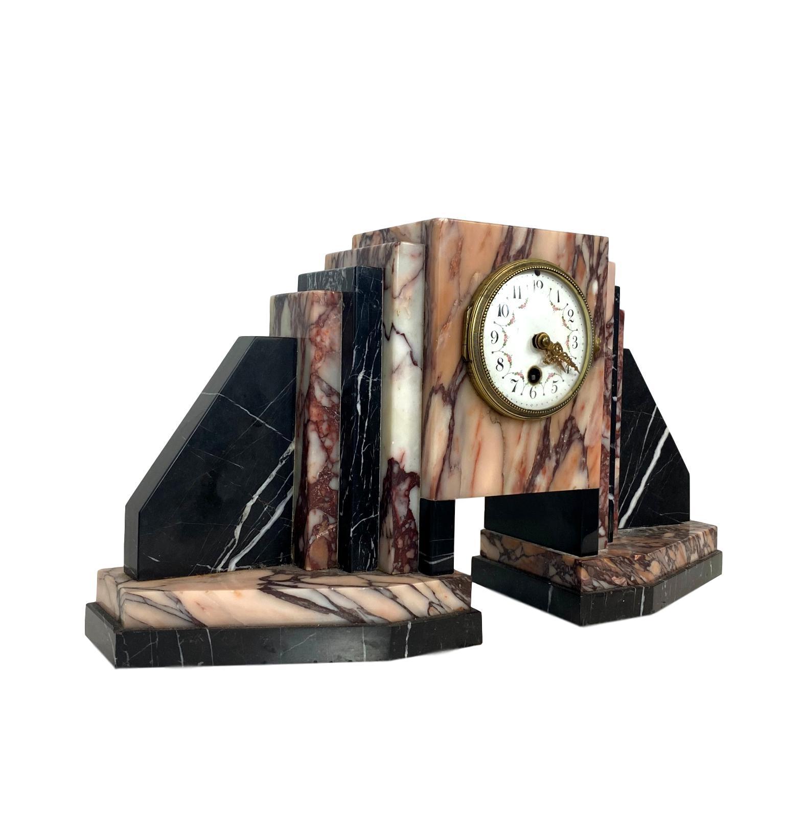 Art Deco moderne marble bookends mantle clock, with stepped and graduated marble books and bookends, French, circa 1930s.