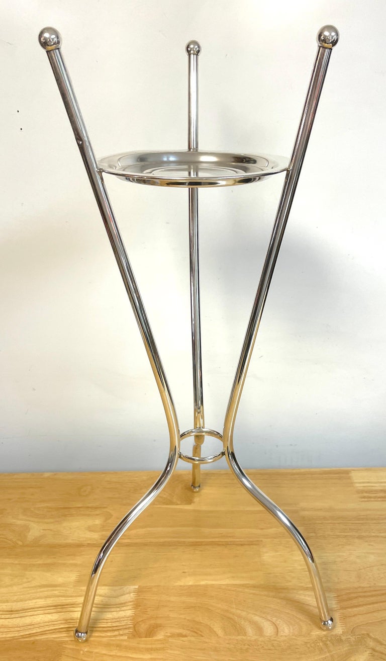 Art Deco/ Moderne Silverplated champagne/wine bucket stand, standing tall and sleek, with influences of the French designer Jean Royère. 
The flowing three splay leg columns topped with ball finials. Supporting a 7.75-Inch diameter champagne/ wine