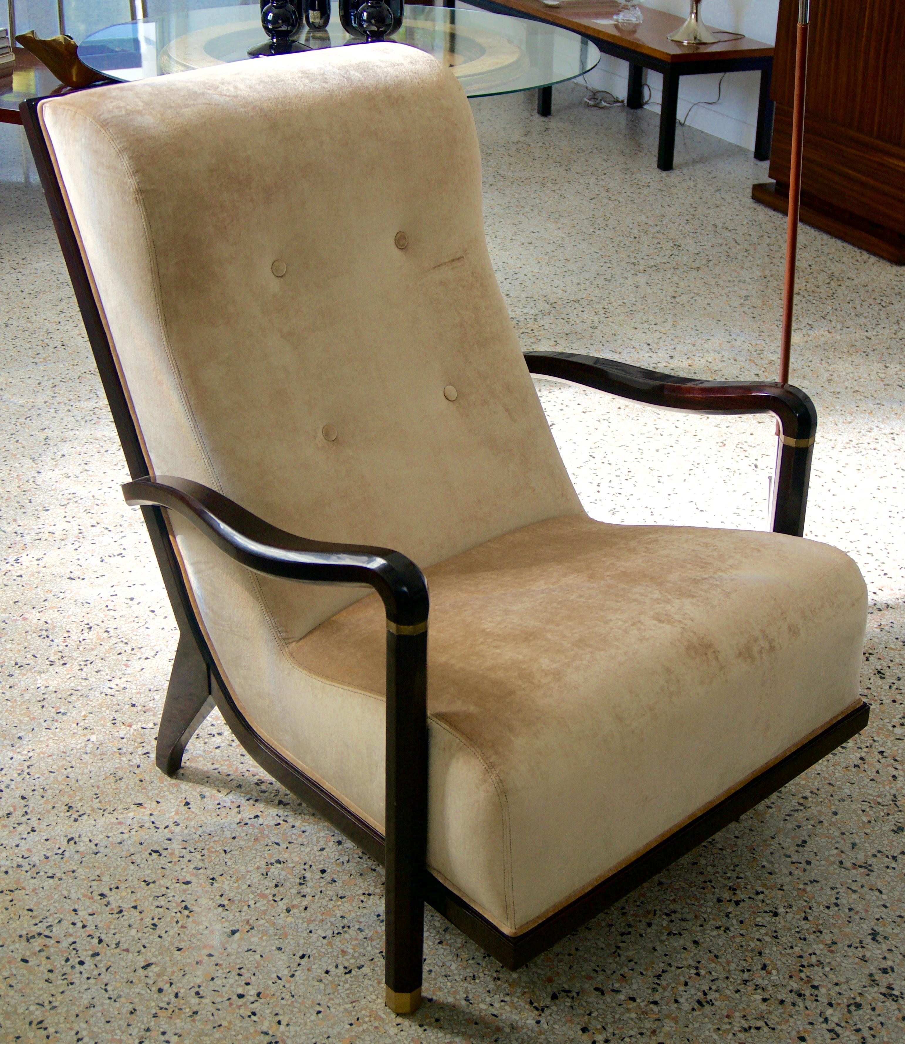 This stylish and chic Art Deco moderne style armchair was created by Lucien Rollan for the William Switzer company and is new old stock. The clean lines and form are very much in the style of pieces created by Andre Arbus. The fabric is a soft,