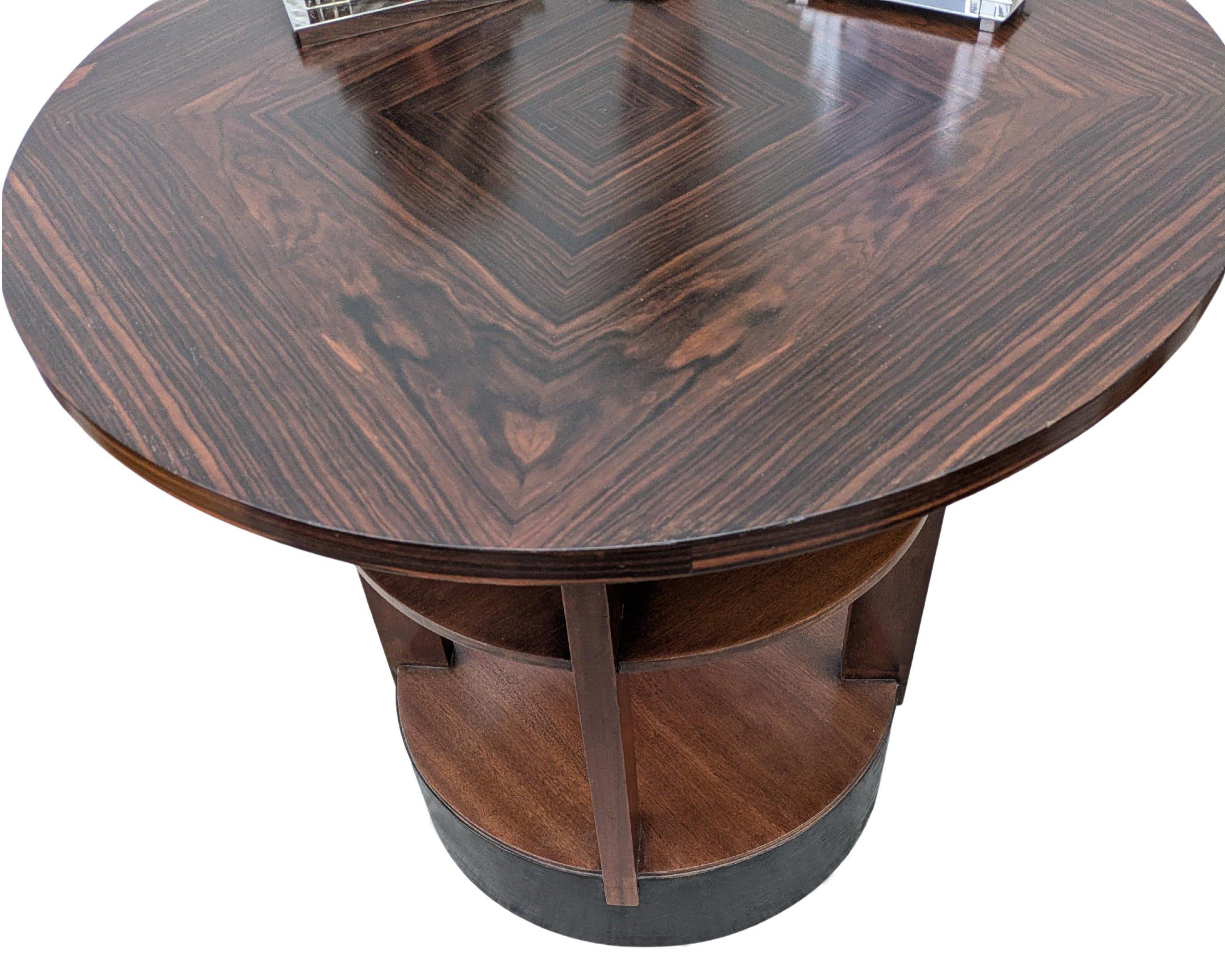 For your consideration is this wonderfully stylish modernist centre table is the luxury woods of ebony Macassar which dates to the 1930's. Originating from France and is typical is it's mix of materials of Macassar wood and ebonized plinth. Standing