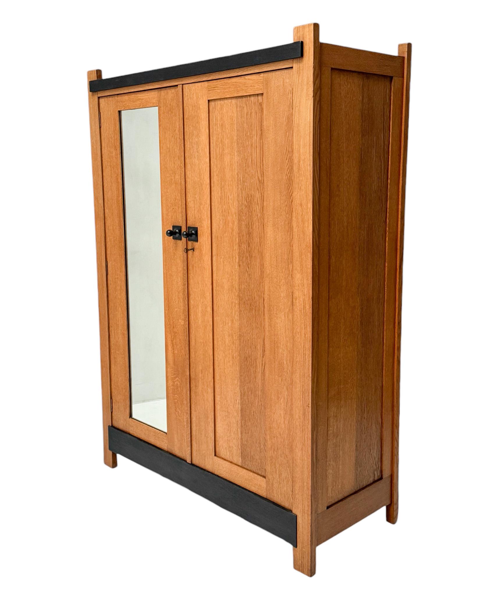 Magnificent and rare Art Deco Modernist armoire or wardrobe. Design by Hendrik Wouda for H. Pander & Zonen Den Haag. Striking Dutch design from the 1920s. Solid oak with original black lacquered wooden knobs. The left door has still the original