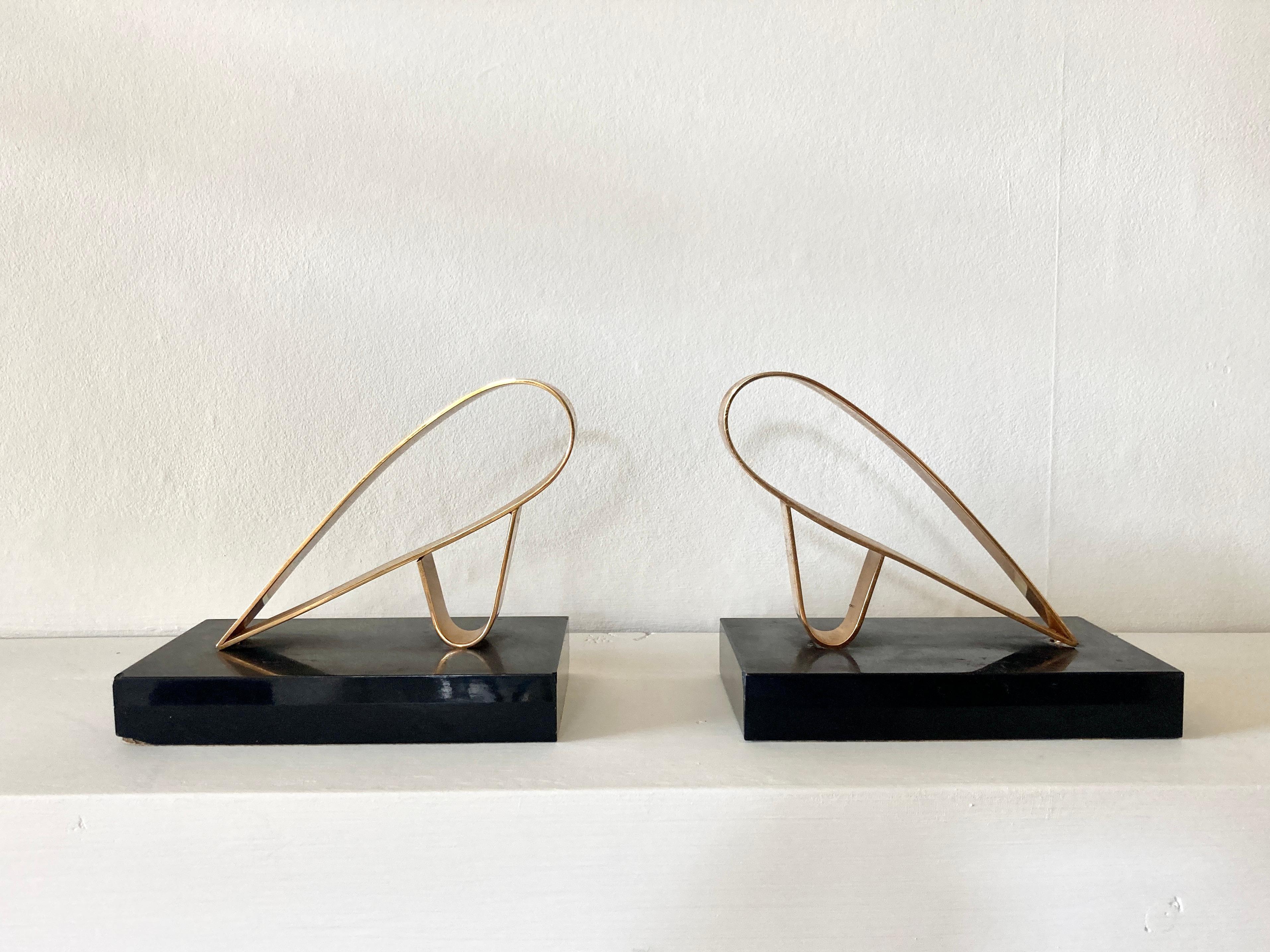 Pair of modernist bookends by the company Gold-Starry of Paris, France. 

Gold plated abstract sculptural forms on black marble. The baize on the underside of the plinths bears the company name.

Founded in 1912, Gold Starry was known for their