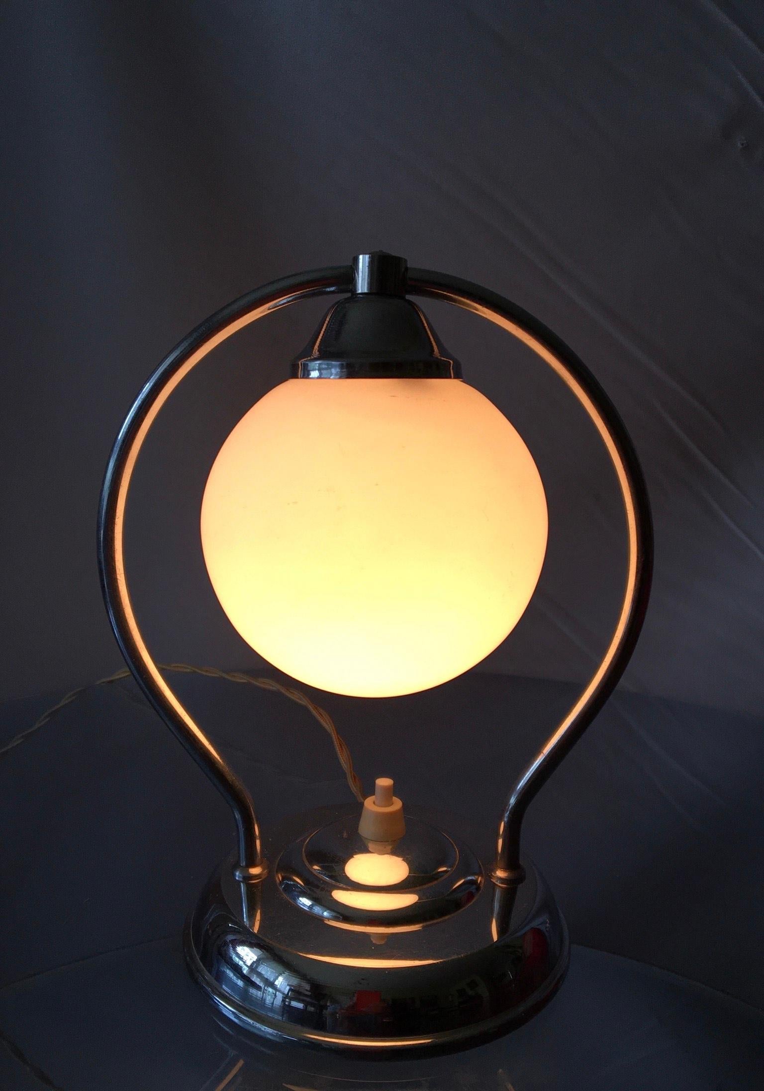 Beautiful and rare French Art Deco Modernist style lamp of the 30’s in chrome plated brass with opaline globe white mat.
The lamp is in an excellent condition, electrical parts checked, switch on/off changed, and rewired with old-fashioned braided