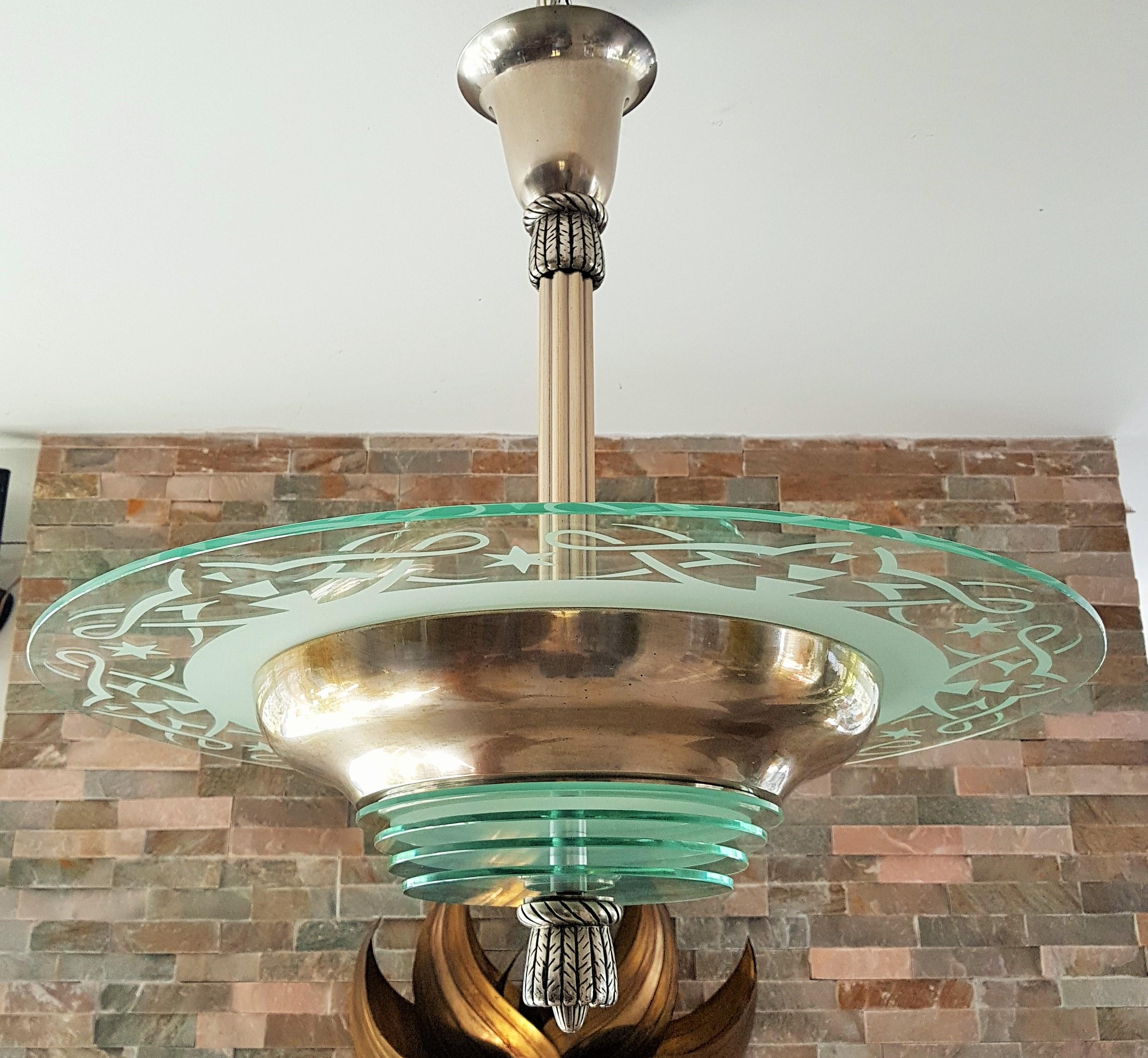 Art Deco modernist chandelier by Petitot, France, 1935.
Original platetd surface with patina. Original glass plate with frosted details with no chips. Nice bronze details. Rewired.
            