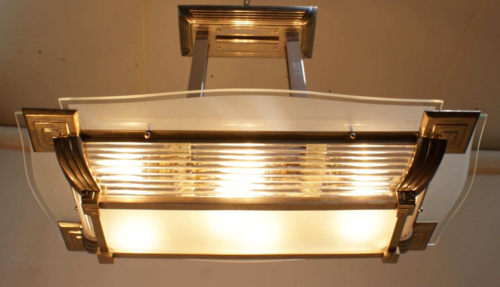 Large rectangular modernist chandelier with a nickel-plated bronze structure and glass tubes, typical of the Art Deco period.
   