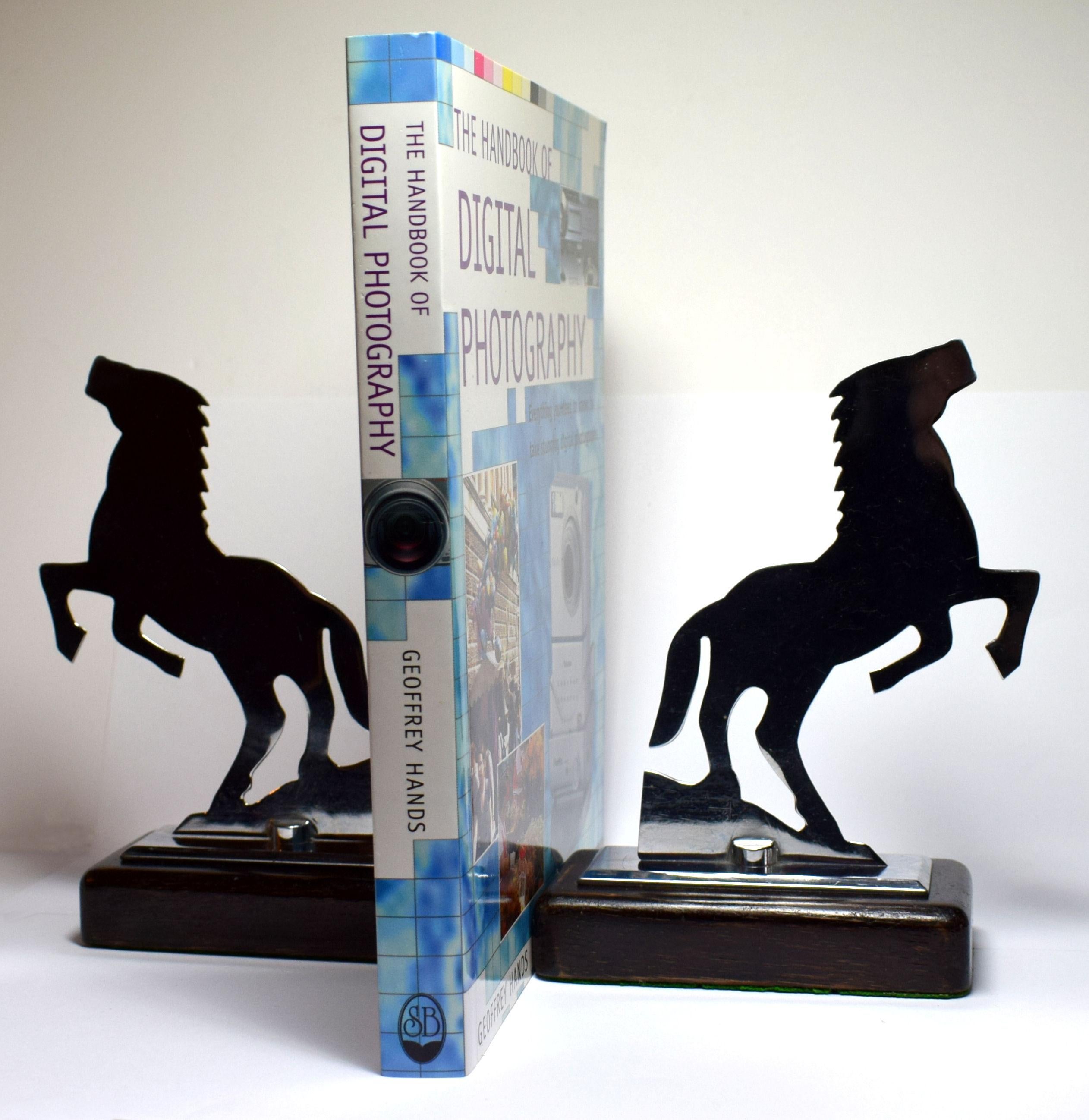 Very stylish and rare two dimensional bookends depicting two rearing stallions. Both are totally authentic and originate from the 1930s. These fabulous Art Deco bookends rest on a mahogany hard wood base. The chrome and the bases are in mint