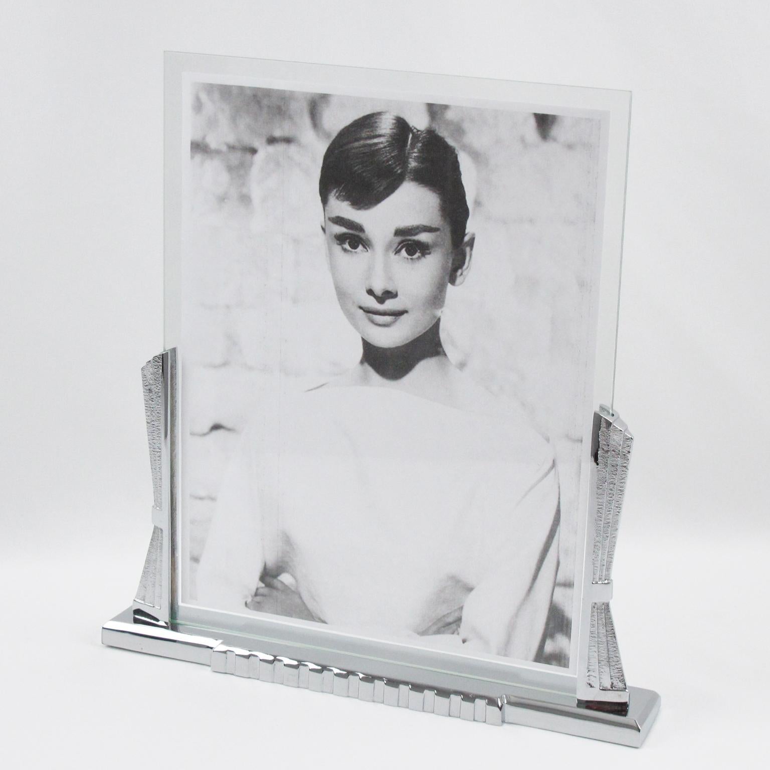 This elegant French Art Deco picture photo frame features impressive quality builds with polished chrome metal shaped as a silhouetted stylized curtain drapery on either side of the picture opening. The large base is in polished chrome with