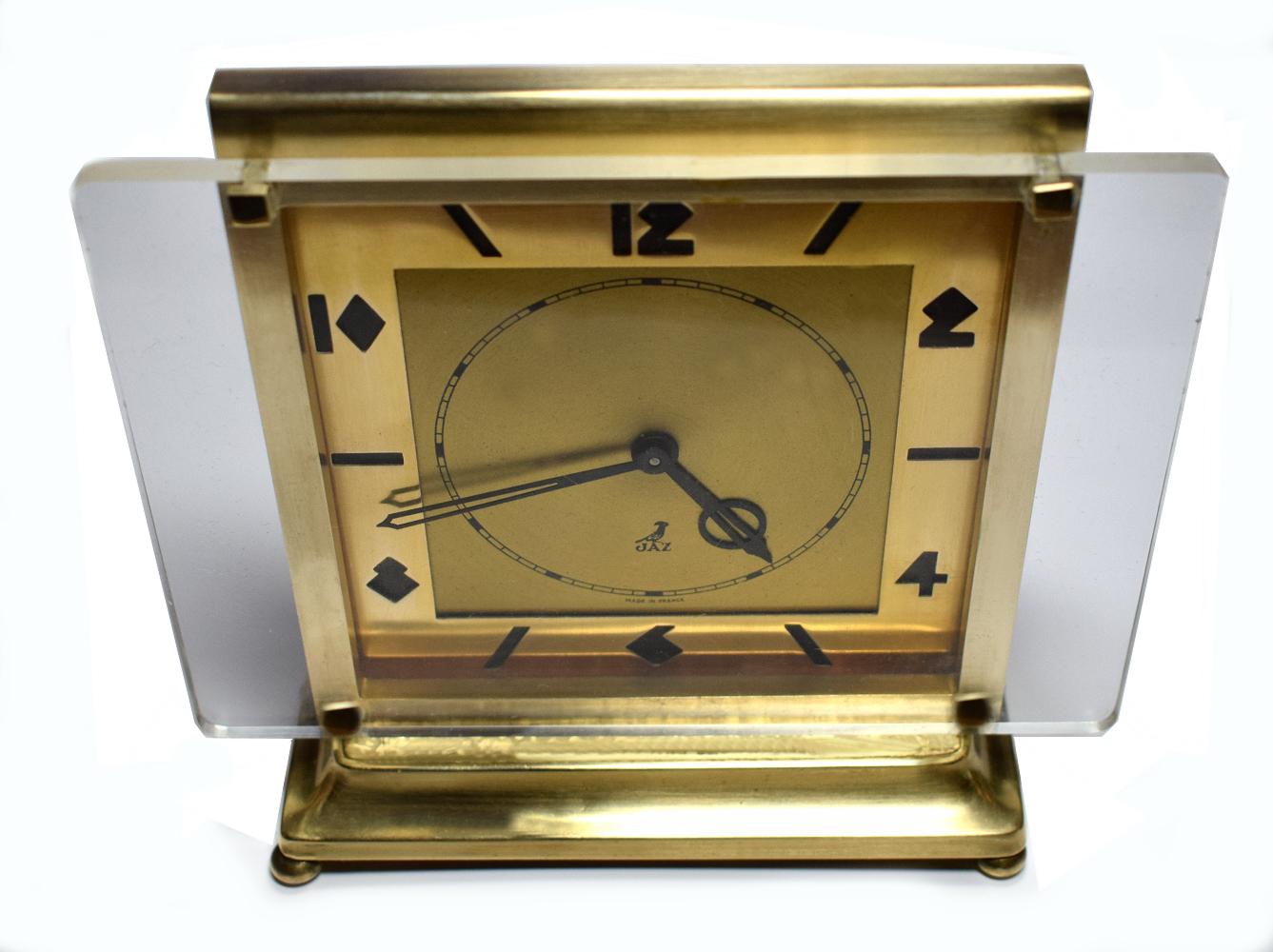 For your consideration is this wonderfully styled Art Deco 1930s French clock made by JAZ, clockmakers of France. Primarily a brass case with a Lucite front of dial. Superbly styled Deco numerals which really are the hero looks wise for this clock.