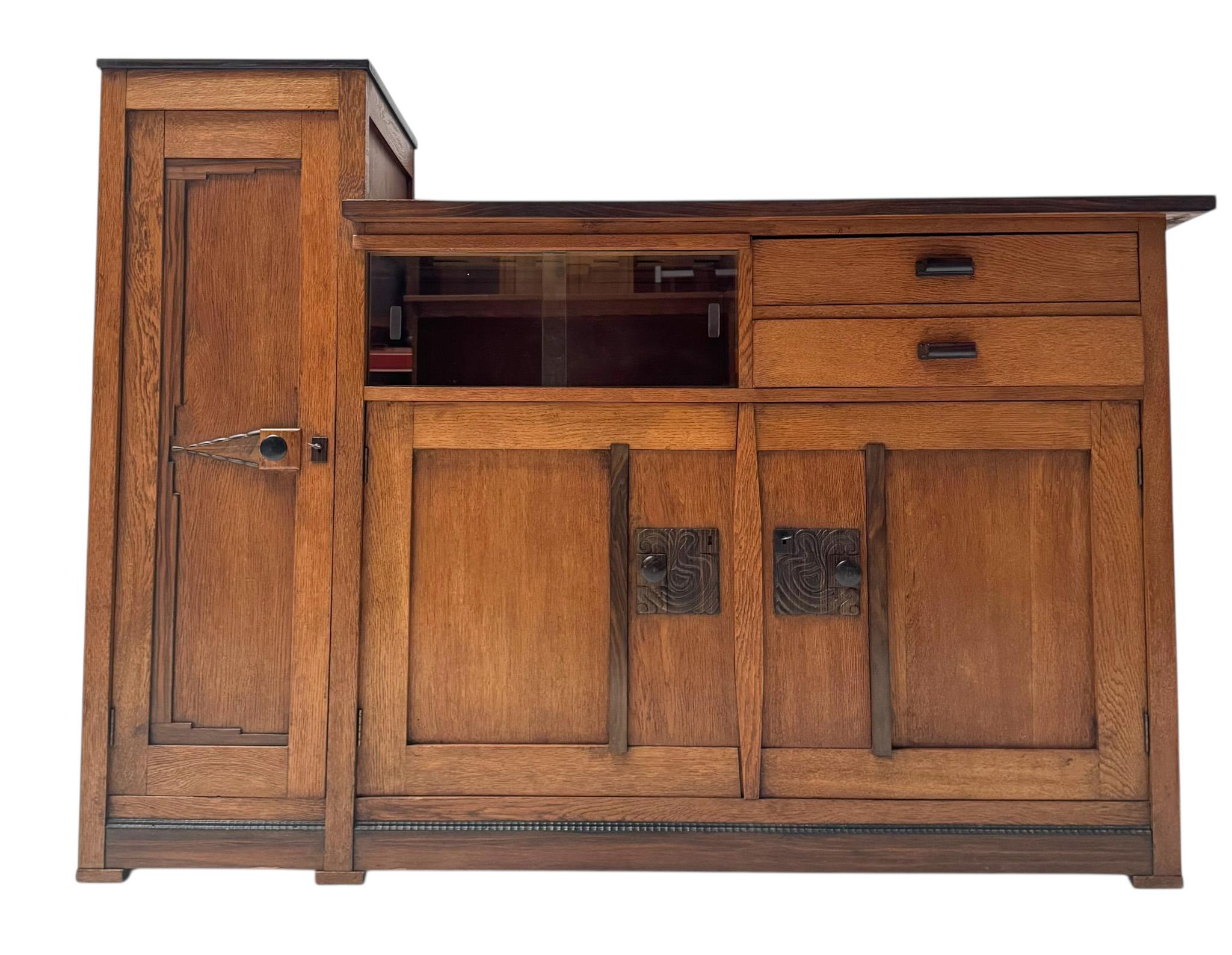 Stunning and elegant Art Deco Modernist credenza or sideboard.
Striking Dutch design from the 1920s.
Solid oak and original oak veneered base with original macassar ebony veneered small top.
Original solid macassar ebony knobs on the doors together
