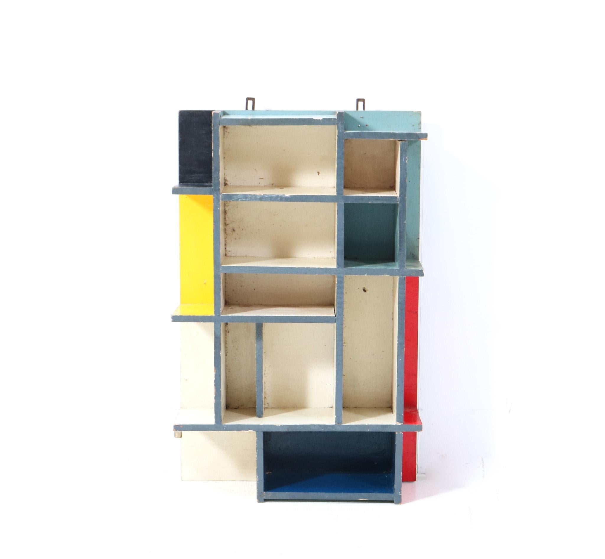 Stunning and rare Art Deco Modernist De Stijl wall cabinet.
Striking Dutch design from the 1940s.
Original hand-painted plywood frame in the typical De Stijl colors.
In very good original condition with minor wear consistent with age and use,