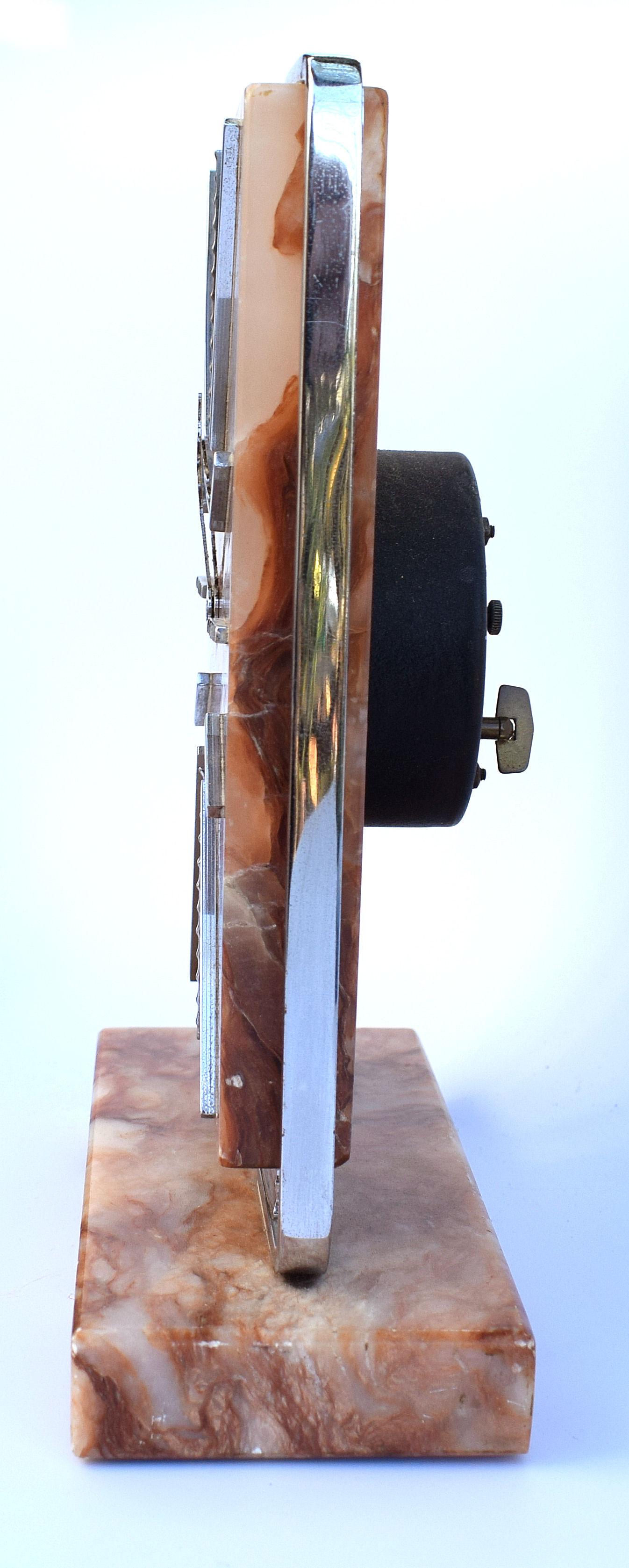 Very impressive Art Deco modernist English clock, made from onyx and dating to the 1930s. The case is solid multicolored onyx, the frame and numerals are chromed metal. A rare design not often found. Really nice size and ideal as a mantle or desk