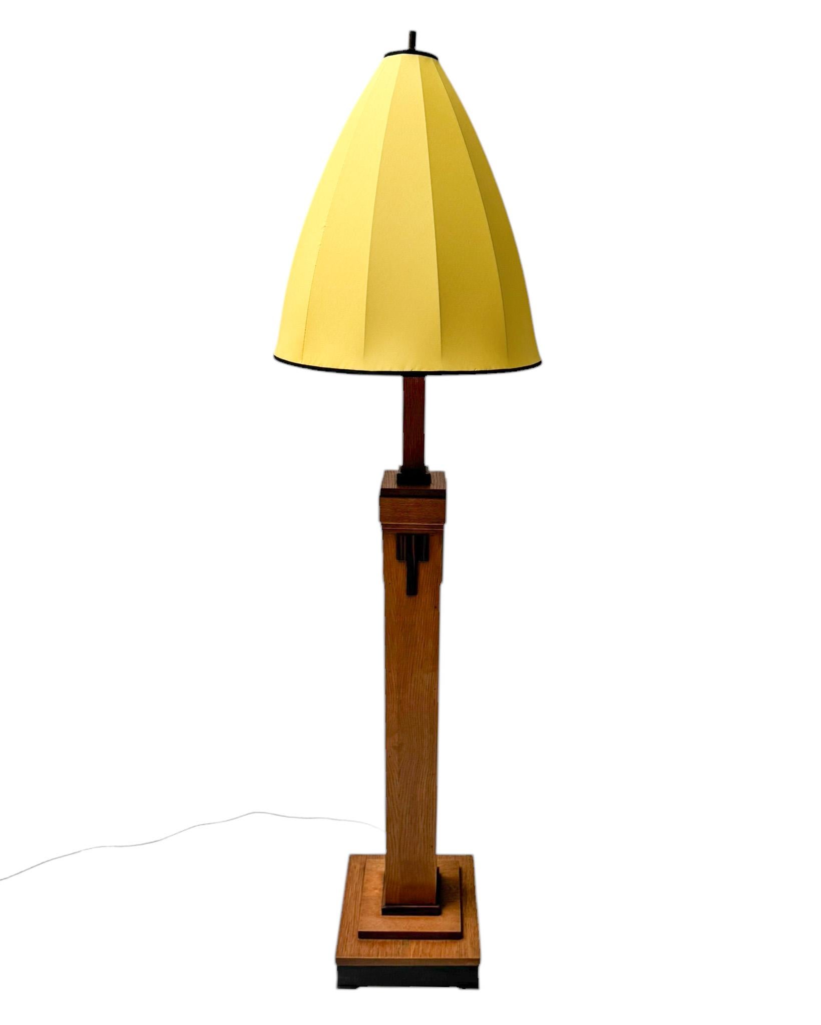 Magnificent and rare Art Deco Modernist floor lamp.
Striking Dutch design from the 1920s.
Original solid oak base with solid macassar ebony decorative elements.
Shade has been re-upholstered with yellow Shantung silk.
Rewired with one original