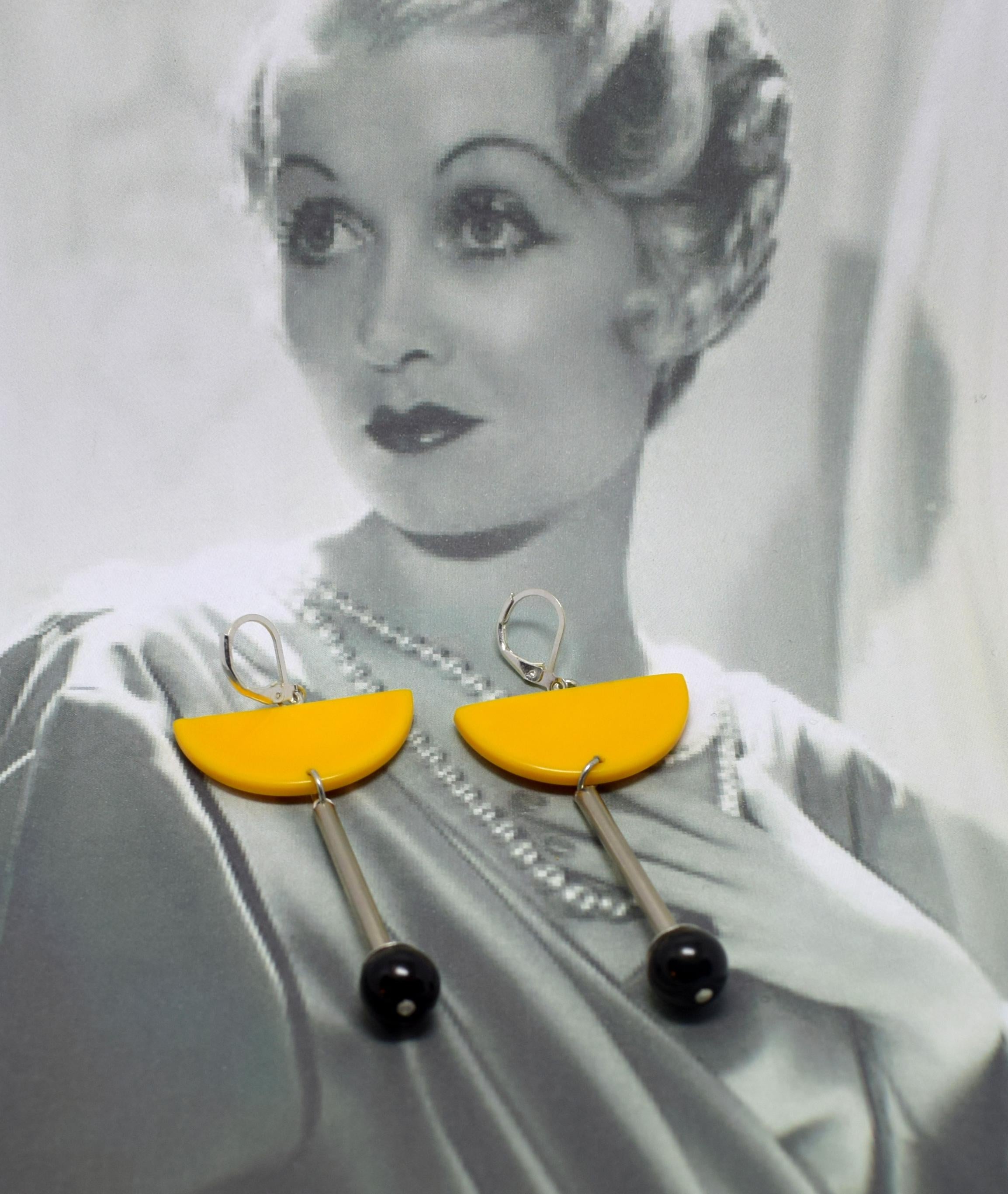 These look wonderful on and definitely will appeal to those ladies with a true sense of individual style.  Yellow yolk coloured Galalith (sometimes called French bakelite) , chrome with Jet accent to the base. The levers are silver. Great modernist