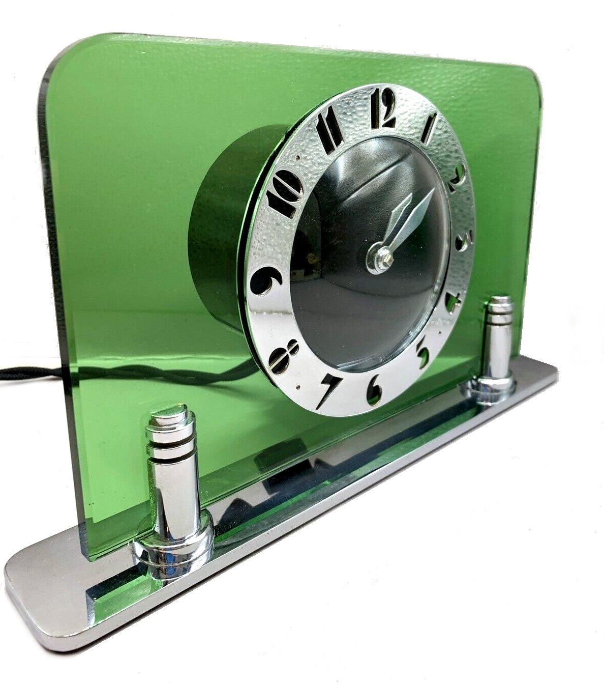 Original 1930's Art Deco Modernist Green glass and chrome clock by the English clock makers Smiths. Beautiful pea green glass with a black dial face and fretted chrome stylised deco numerals. Fabulous condition, full working order. This is Art Deco