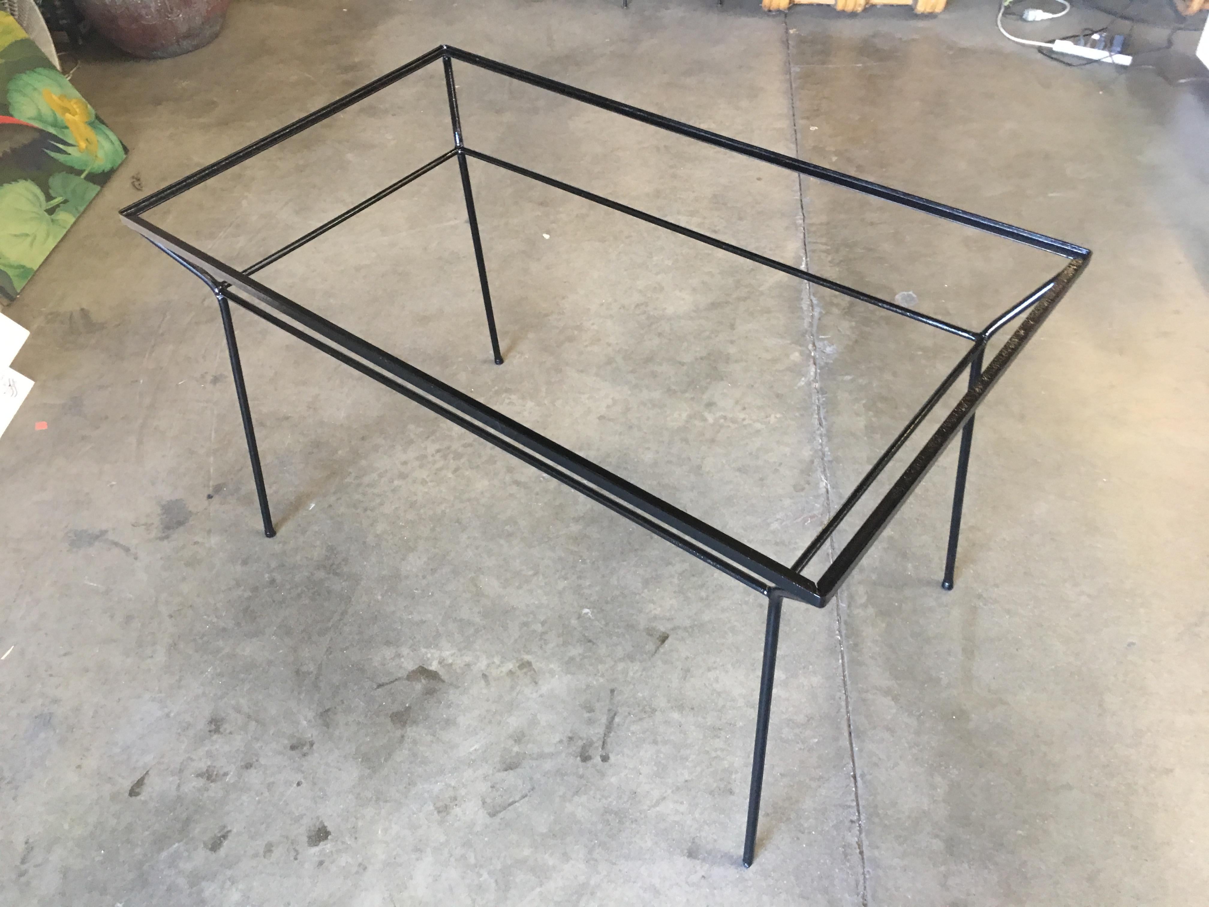 Rare Art Deco iron and glass outdoor dining table featuring a geometric form and petite frame, circa 1940.