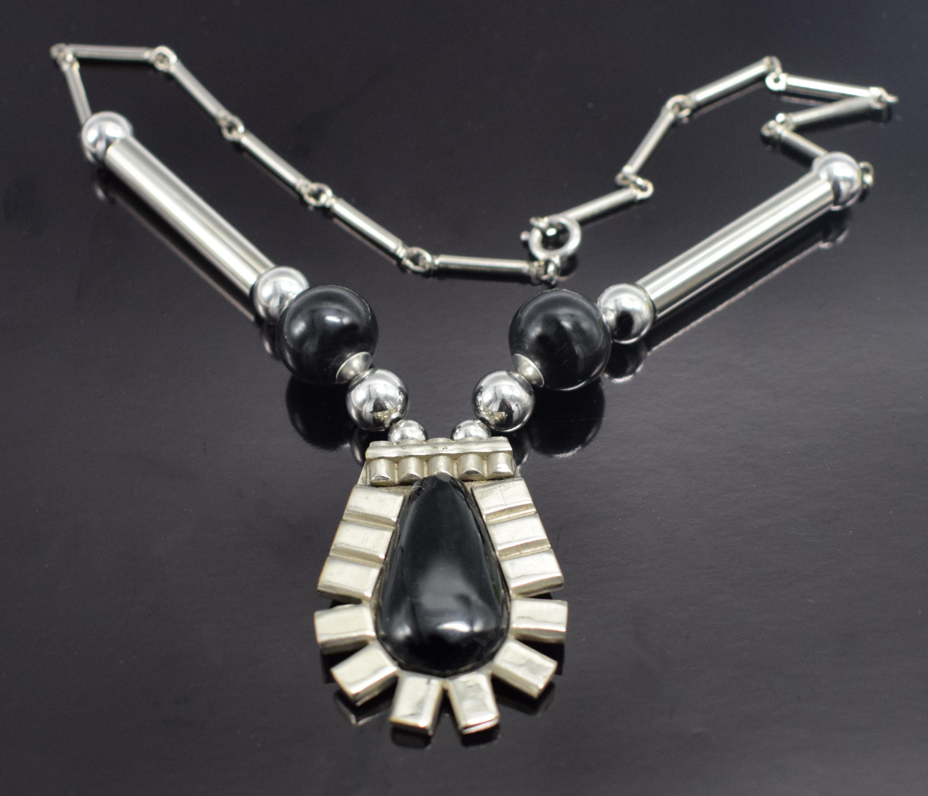 Classic and very high quality ladies Art Deco Modernist necklace by Jakob Bengel dating to the 1930's. Features black glass tear drop centre stone with fan shaped panels of chrome surround. Jakob Bengel was one of the leading manufacturers of Art