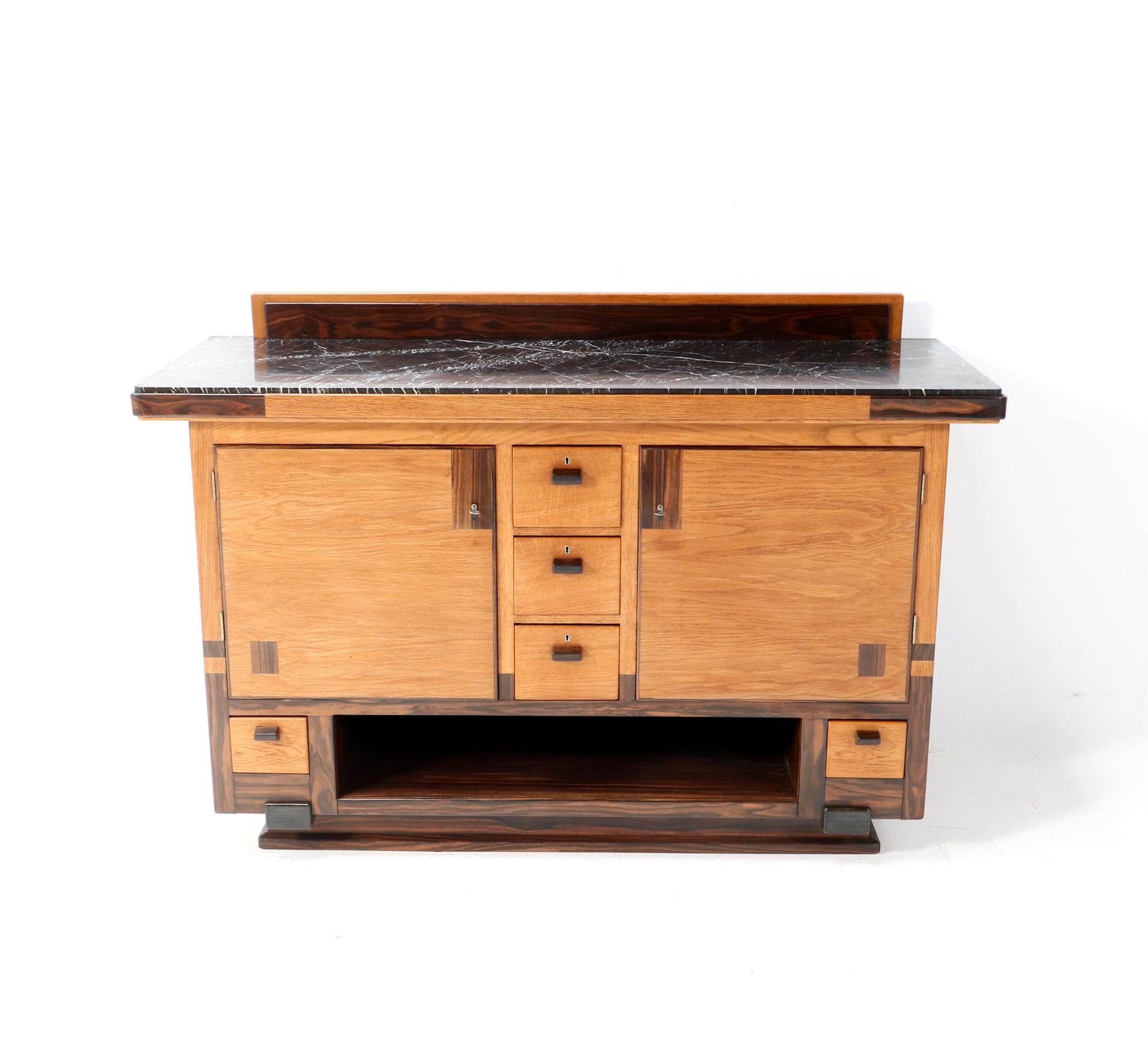 Magnificent and ultra rare Art Deco Modernist credenza or sideboard. Design by Anton Lucas Leiden. Striking Dutch design from the 1920s. Solid oak base with original oak and macassar ebony veneered doors. Five drawers with original solid macassar