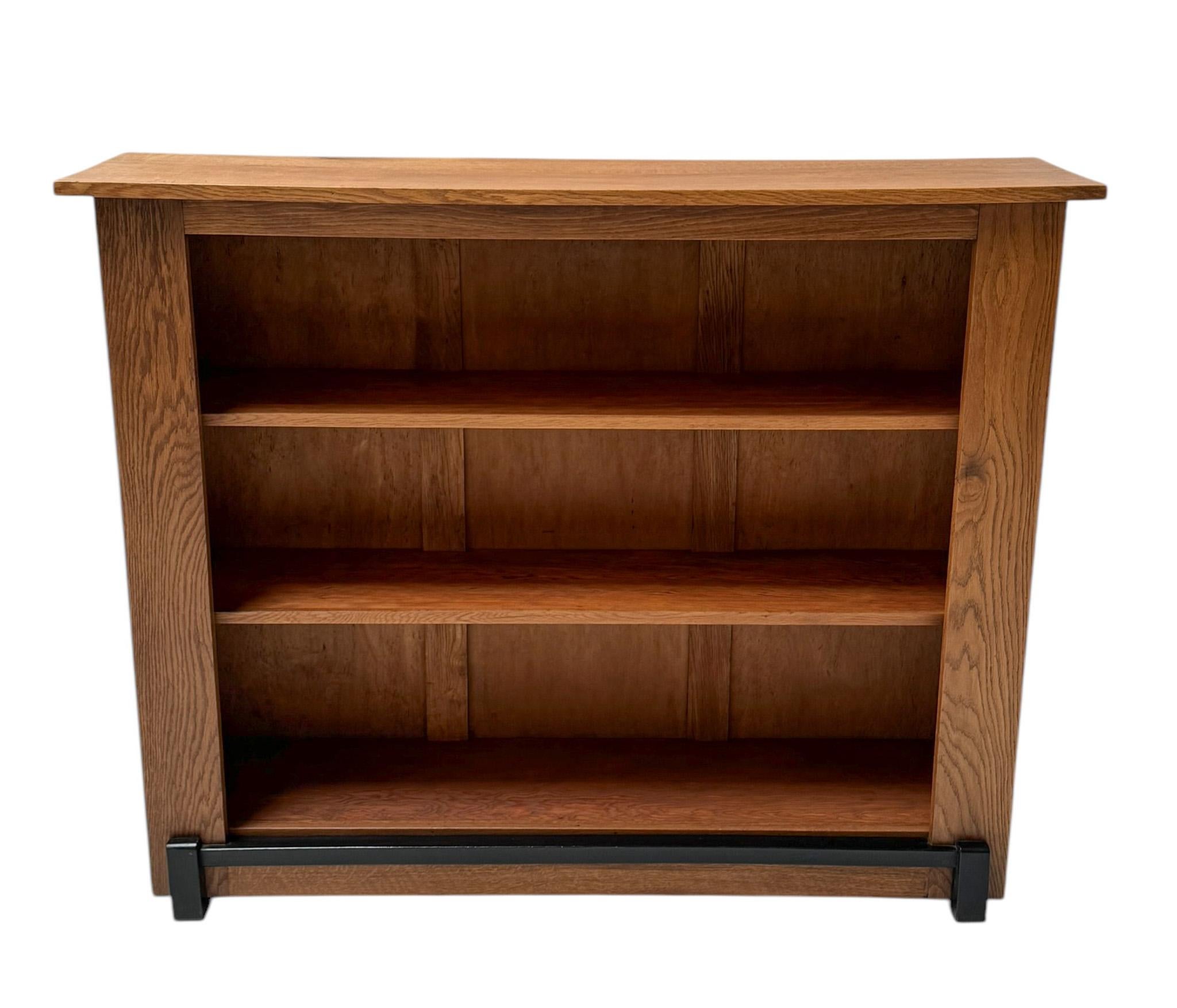 Magnificent and rare Art Deco Modernist open bookcase.Design by Jan Brunott.Striking Dutch design from the 1920s.Solid oak base with original black lacquered lining.Two original pine with oak shelves.This wonderful Art Deco Modernist open bookcase