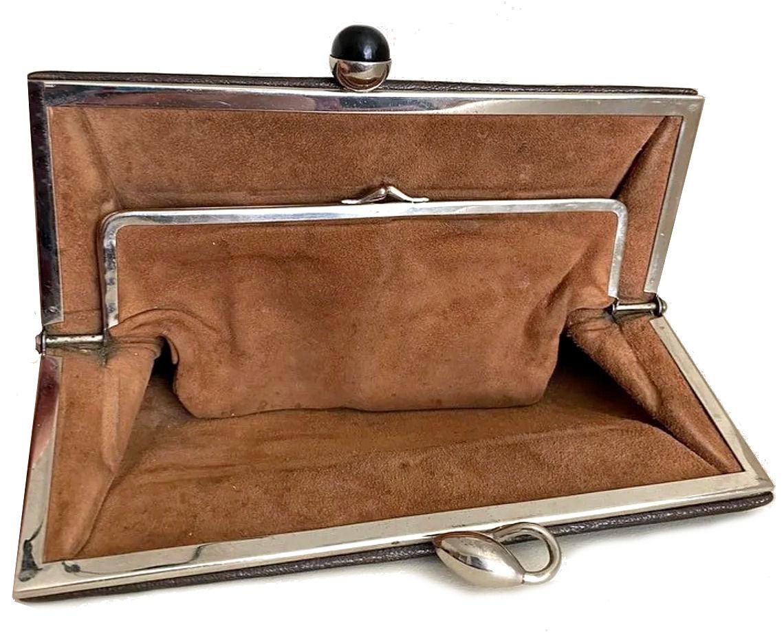 For your consideration is the original Art Deco super stylish leather handbag, a great example of Modernist Deco design of the 30's period. Features a dark brown leather body with tan suede interior, has an integral coin purse & inside pocket, Label