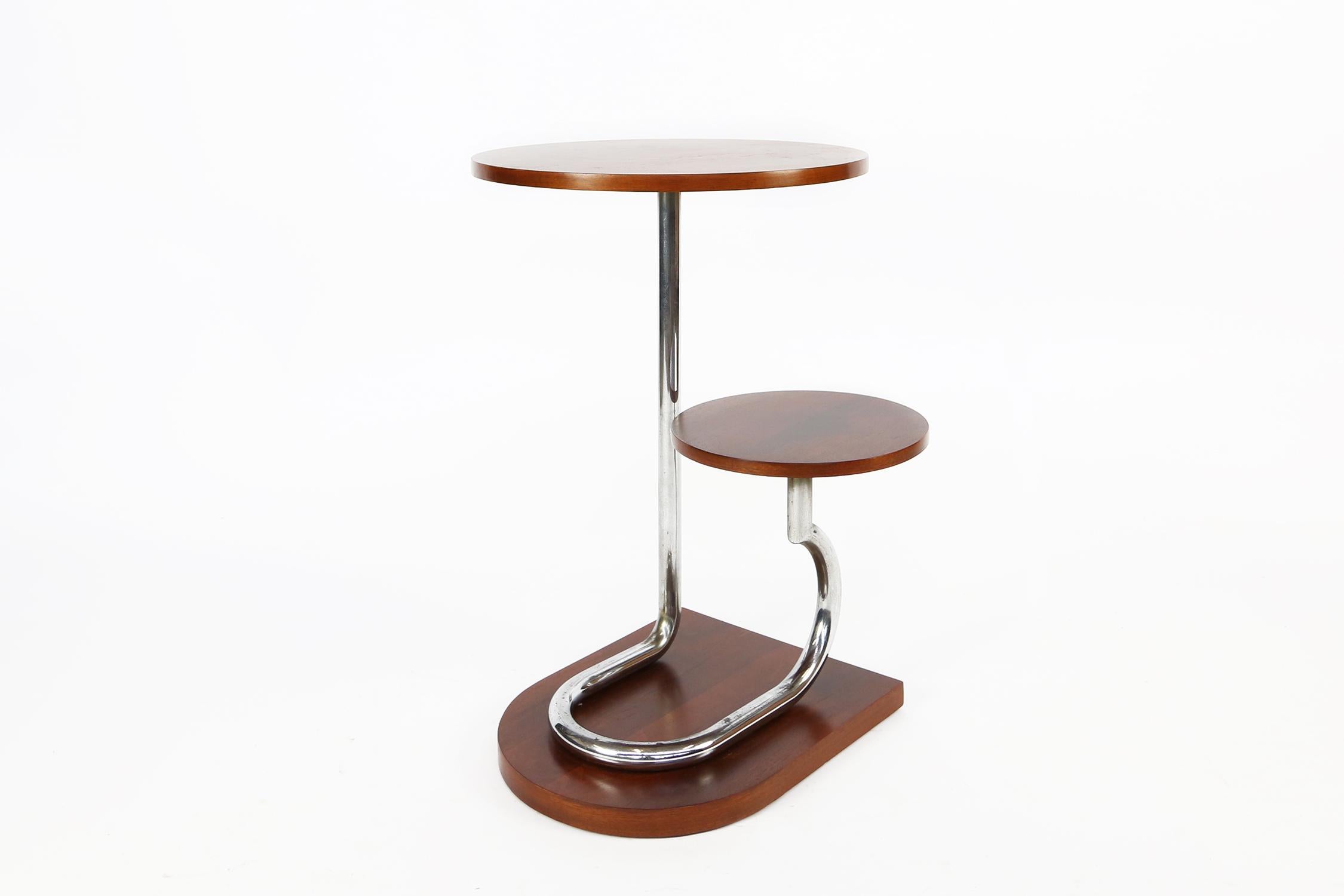 Stylish and totally authentic French, Art Deco Gueridon, dating to the 1930s. This fabulous table is great to display items, or as plant stand. Features two-tiered circular platforms supported on chrome tubular poles the whole having an asymmetrical
