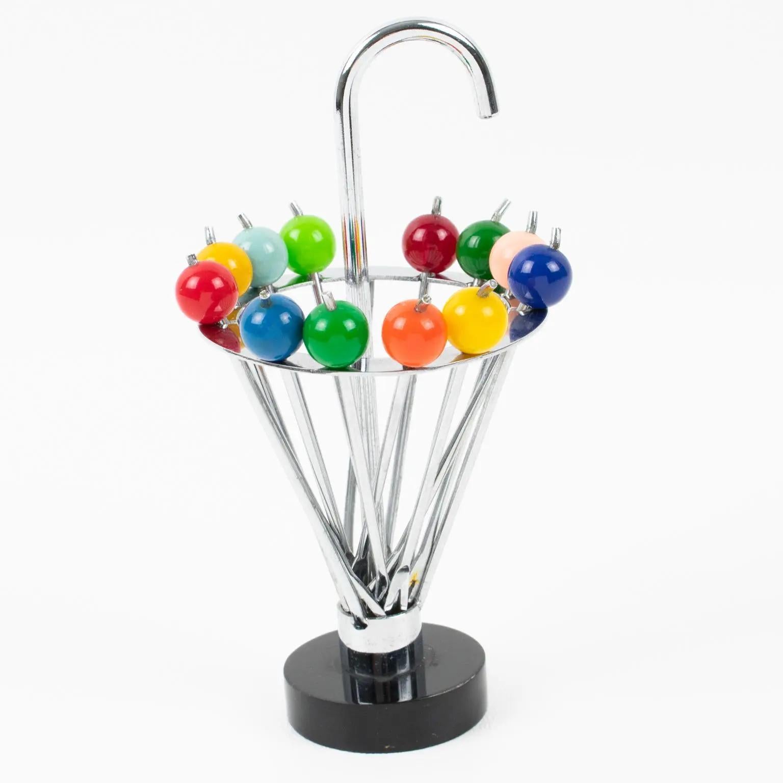 This beautiful barware serving set of French Art Deco cocktail picks features twelve picks with multicolor Lucite finial that can be removed from the metal holder, shaped like an umbrella, and be used as cocktail picks for Manhattans, Martini, or