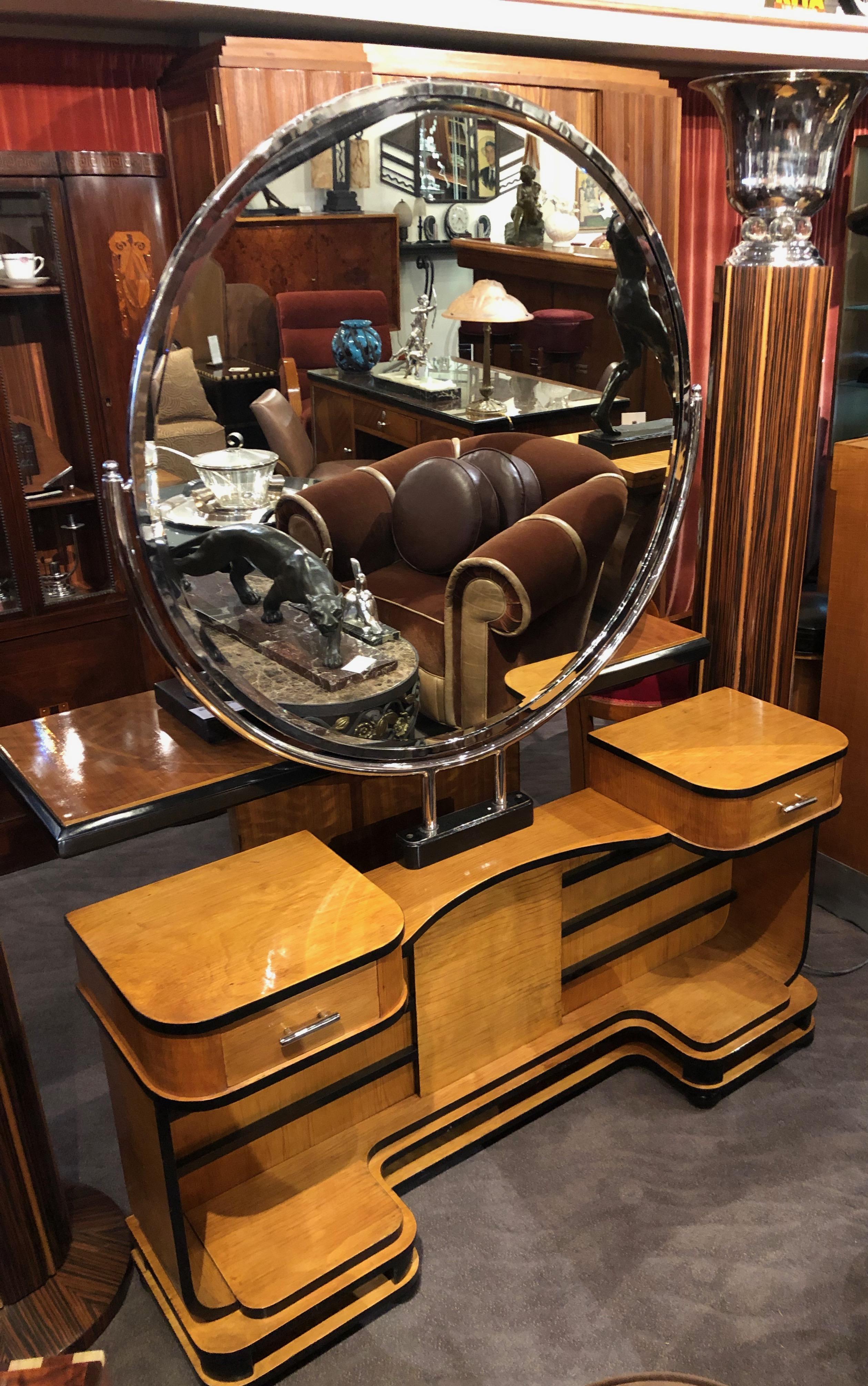 Modernist Art Deco vanity in two-tone wood. Purchased in Argentina, inspired by Europe. This stunning vanity with matching stool is a pleasure to the eye. Large beveled over-sized chrome mirror with slight swivel. Two small drawers with chrome