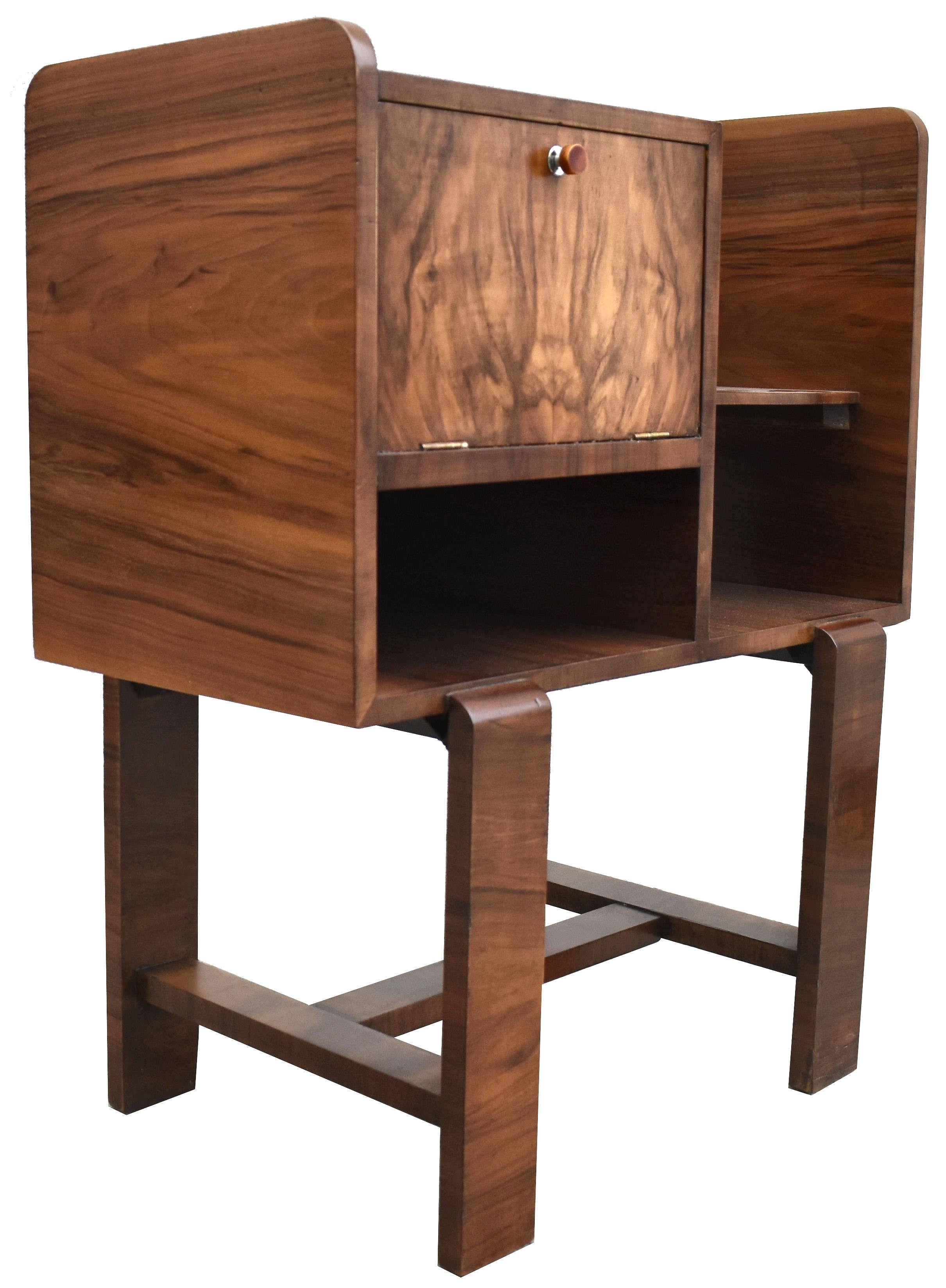For your consideration is this very attractive 1930's beautifully figured Walnut telephone table. Definitely has a bit of a Bauhaus vibe but we believe this piece to be English in origin. Single cupboard with original catalin bakelite handle to