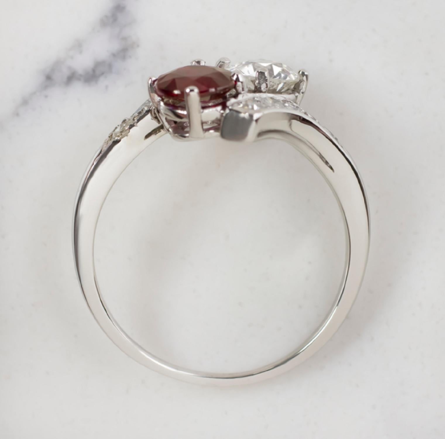 This eye-catching original vintage ruby and diamond ring offers rich contrast, and a dynamic bypass design! The ring features a rich red 0.74ct ruby paired with a vibrant 0.68ct old European cut diamond. The 0.74ct ruby center is certified as