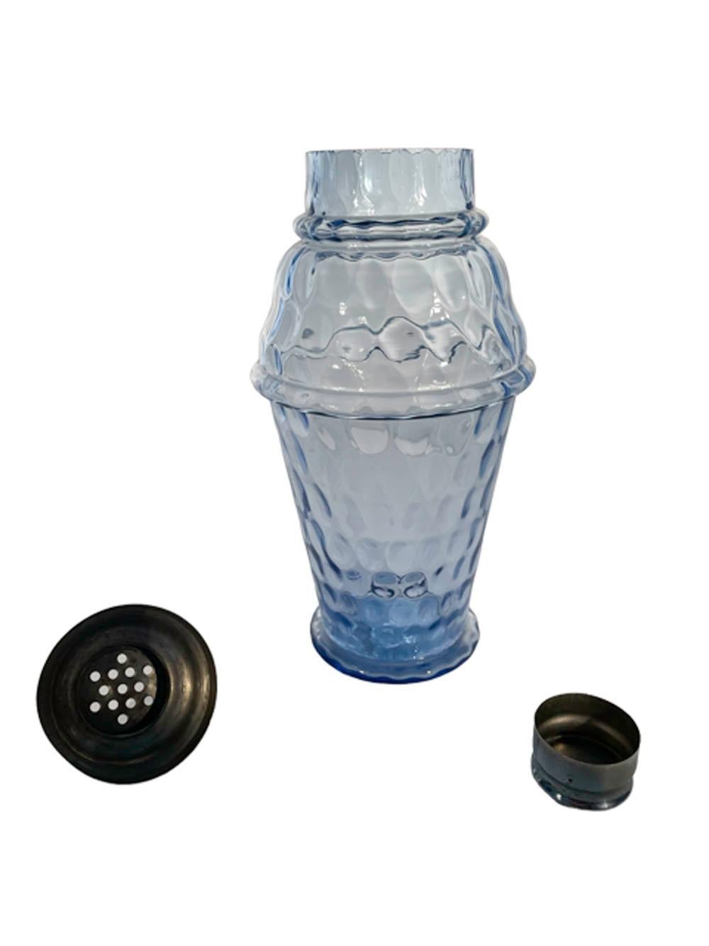 Art Deco molded cocktail shaker in pale cobalt blue glass with all-over thumbprint or coin spot pattern with a domed center pour chrome lid and cap.