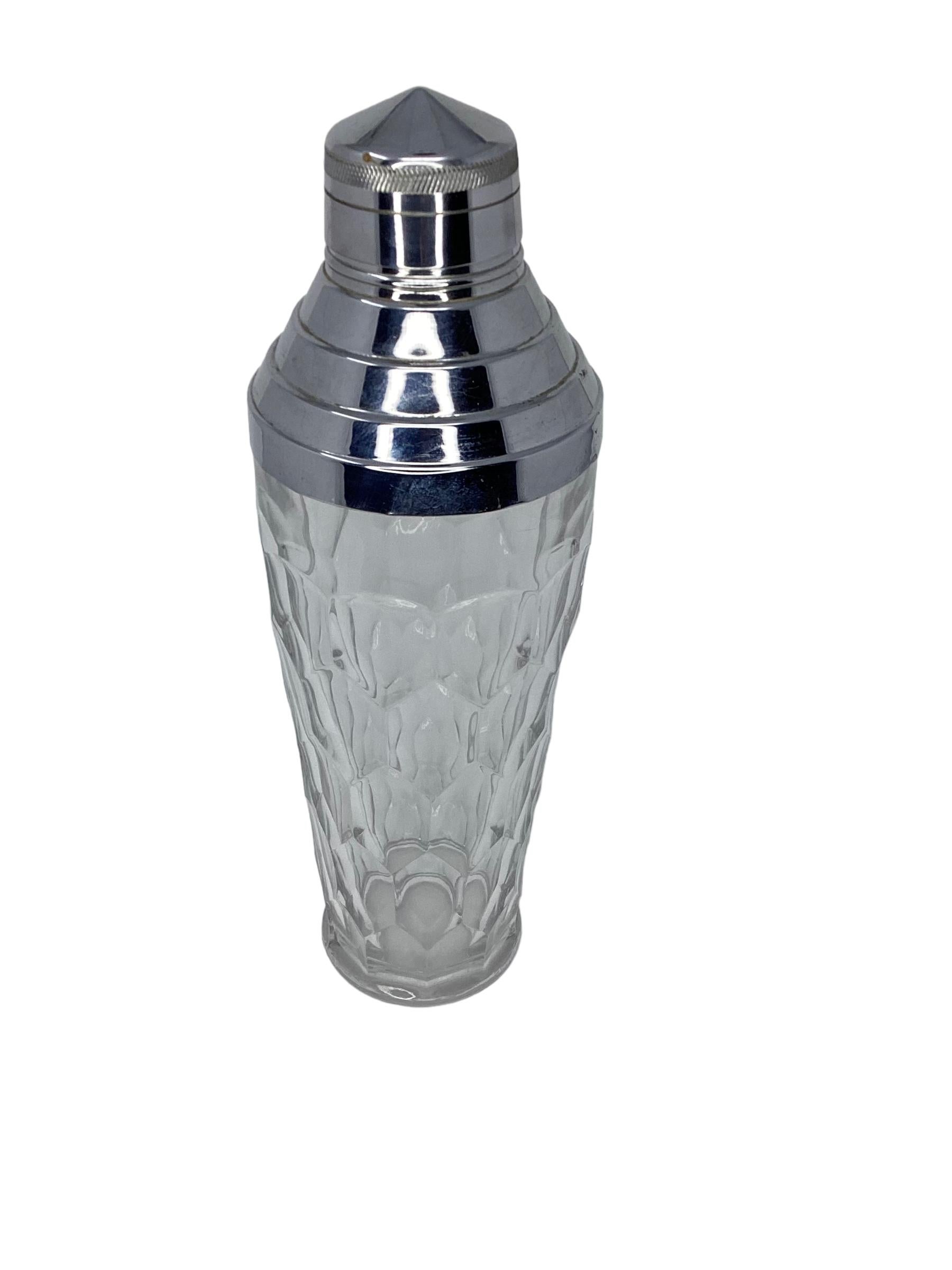 Art Deco molded cocktail shaker in clear glass with diamond pattern. The domed stepped lid features a center pour and is in chrome.