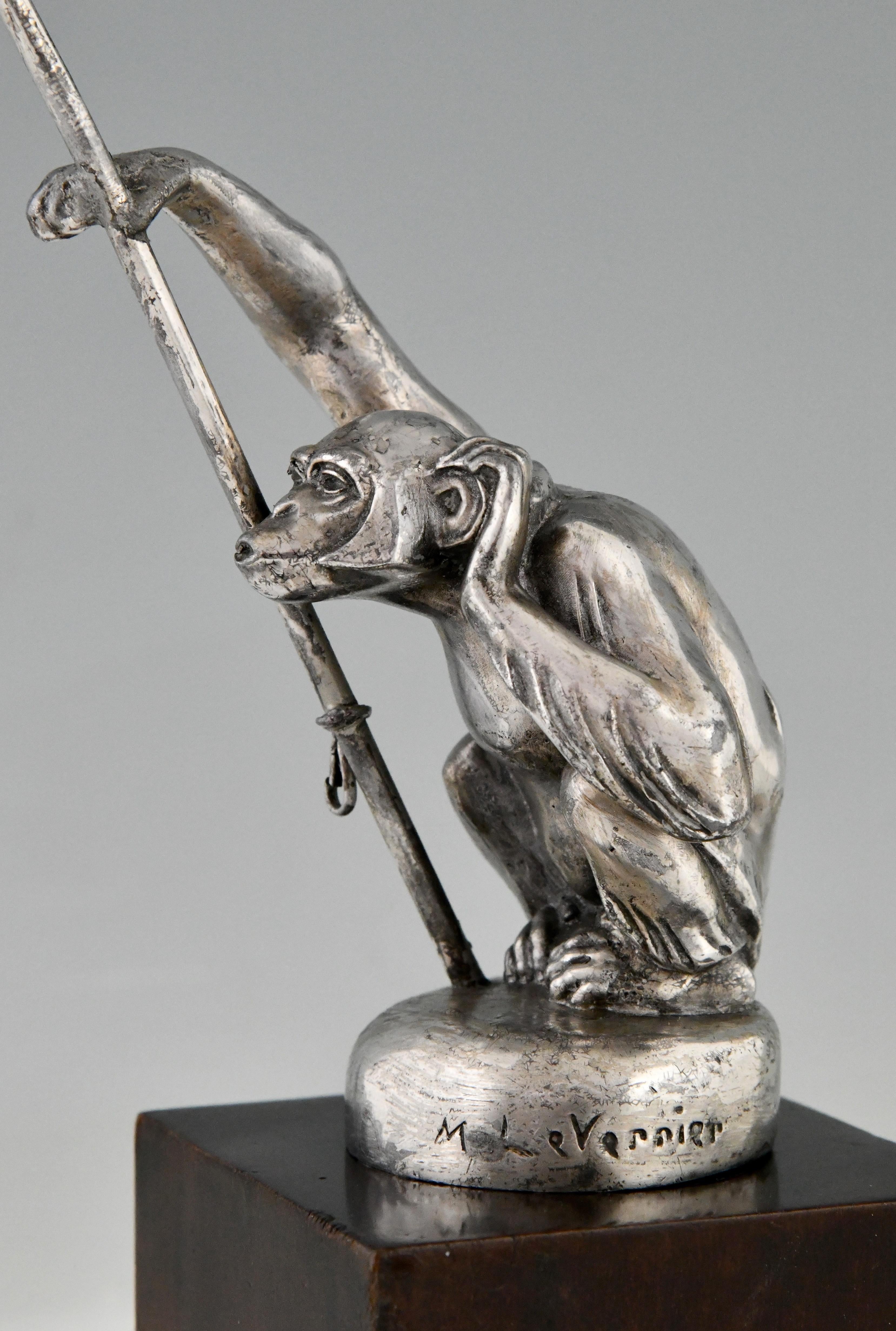 Art Deco monkey car mascot with flag pole Boubou porte drapeau by Max Le Verrier. Metal with original silver patina on wooden base.
France 1920/1930. 
This model hood ornament is very hard to find.
This car mascot is illustrated in the book