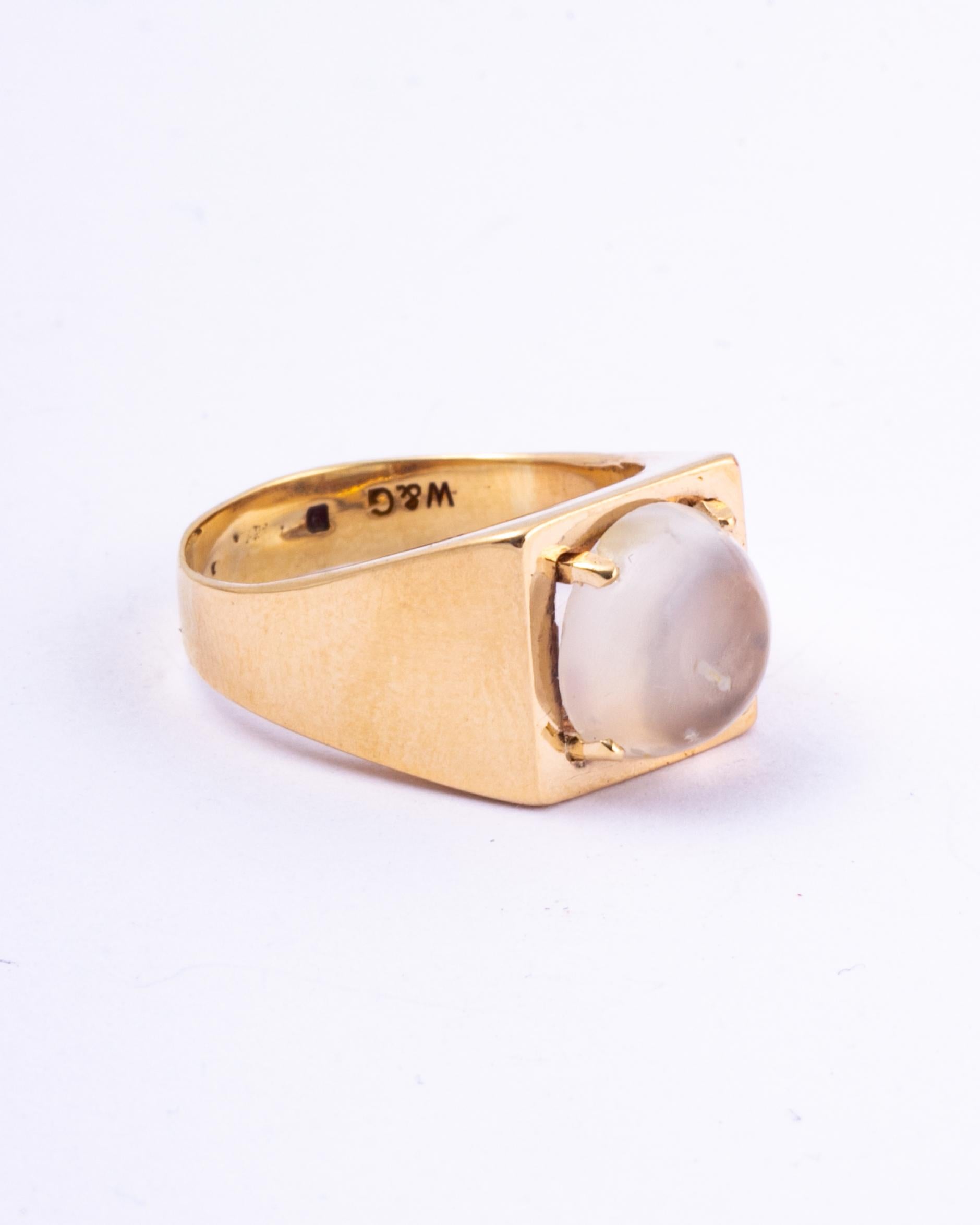 This wonderful glossy 9carat gold band holds a gorgeous moonstone on top. The band is angular in true Art Deco style. 

Ring Size: L 1/2 or 6 
Height Off Finger: 7mm
Stone Diameter: 9mm

Weight: 4.6g
