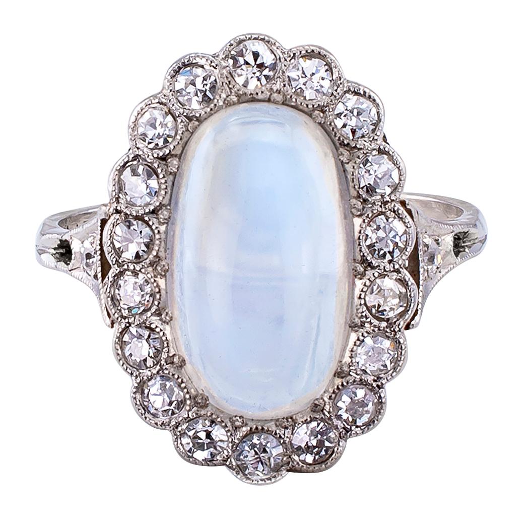 Moonstone and diamond Art Deco platinum ring circa 1930. Featuring an oval moonstone within a conforming border set with twenty old-cut round diamonds totaling approximately 0.50 carat, approximately H – I color and VS – SI clarity, mounted in