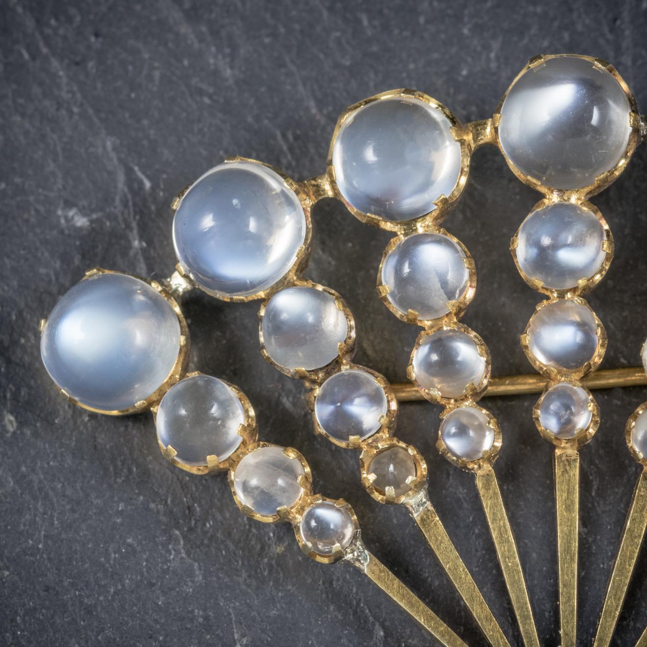 This beautiful Moonstone fan brooch is from the Art Deco period, Circa 1920.

The fabulous piece is adorned with 29 ghostly Moonstones, the largest of which is 3.5ct.

Set in a fancy fan shaped setting which is all 18ct Yellow Gold.

This is a