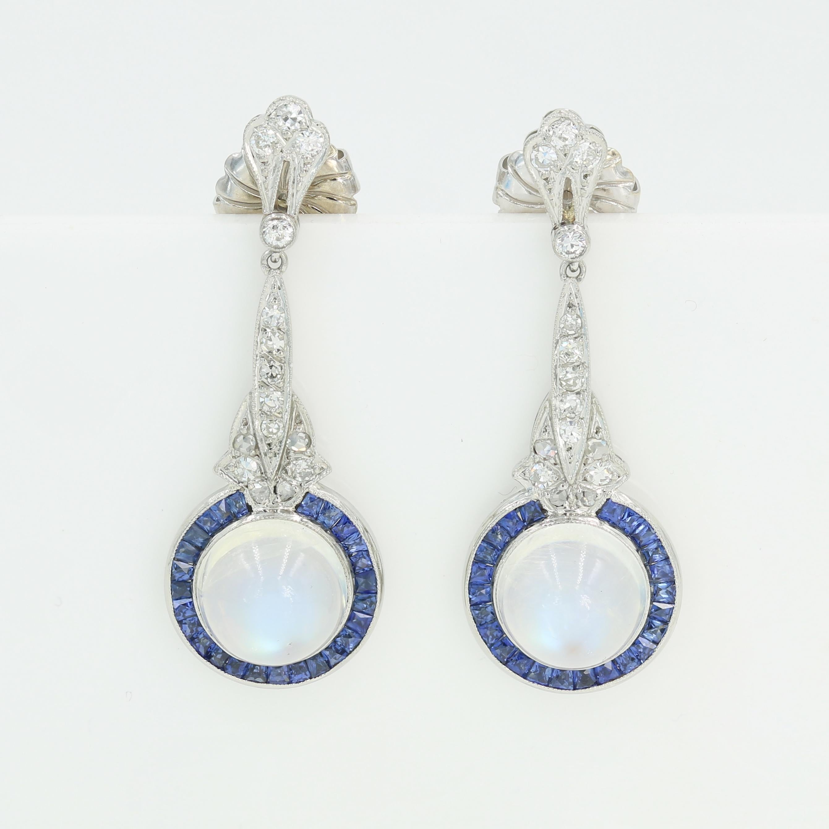 Gorgeous Art Deco Moonstone, Diamond and Sapphire drop earrings with 10.07cts. total weight matched natural Moonstones.  Old and single cut diamonds weighing approximately 0.60ct. total of H/I color and VS/SI clarity.  50 Square cut sapphires