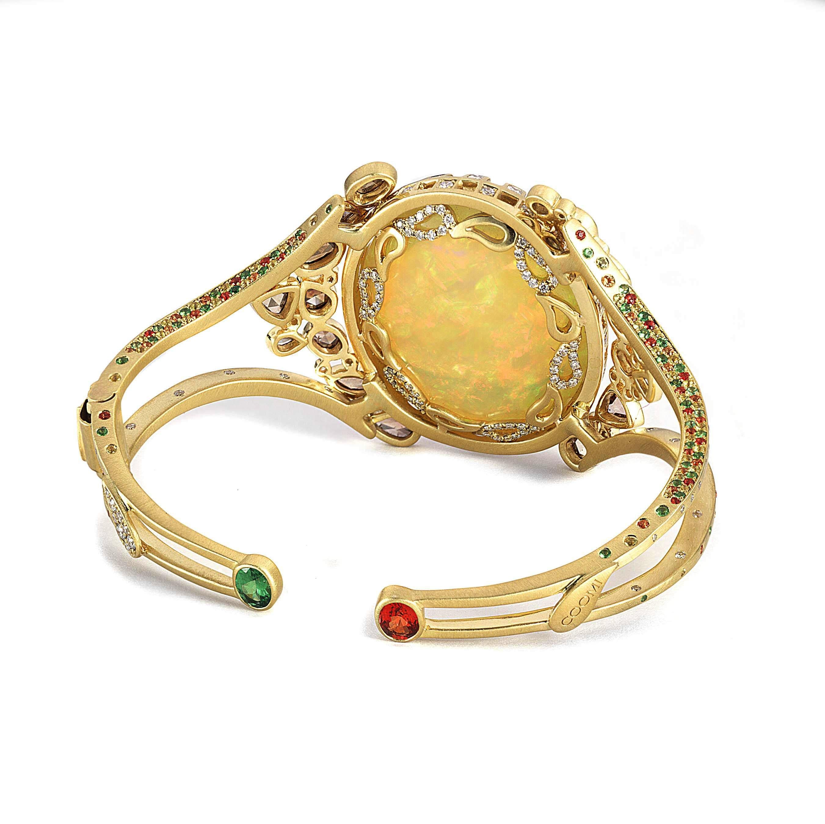 A stunning and bold statement piece set in rich 20 Karat Yellow Gold with Opal weighing approximately at 42.82cts and Diamonds at 2.46cts with brown diamonds 2.90cts. The rare cuff bracelet inspired by Art deco and Mosaic artwork and culture. This