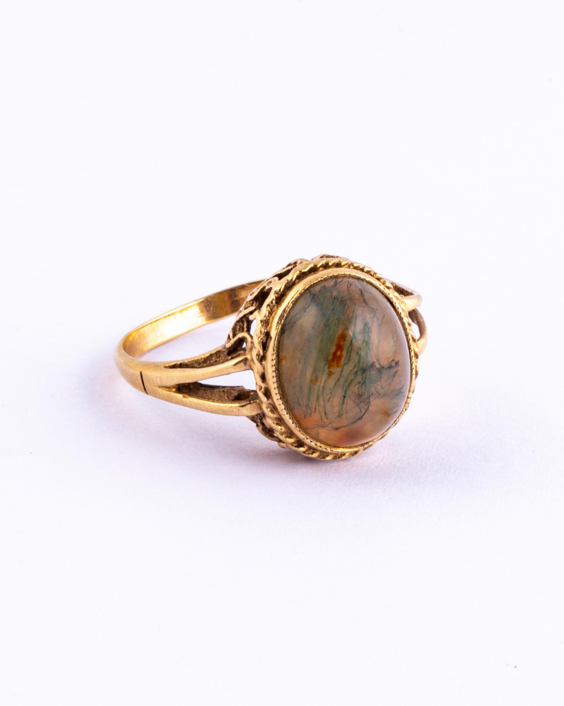 This wonderful moss agate stone has marbling of deep green and amber colour running through. Surrounding the stone there is a simple frame and a gorgeously ornate gallery. Made in Birmingham England. 

Ring Size: P 1/2 or 7 3/4 
Stone Dimensions: