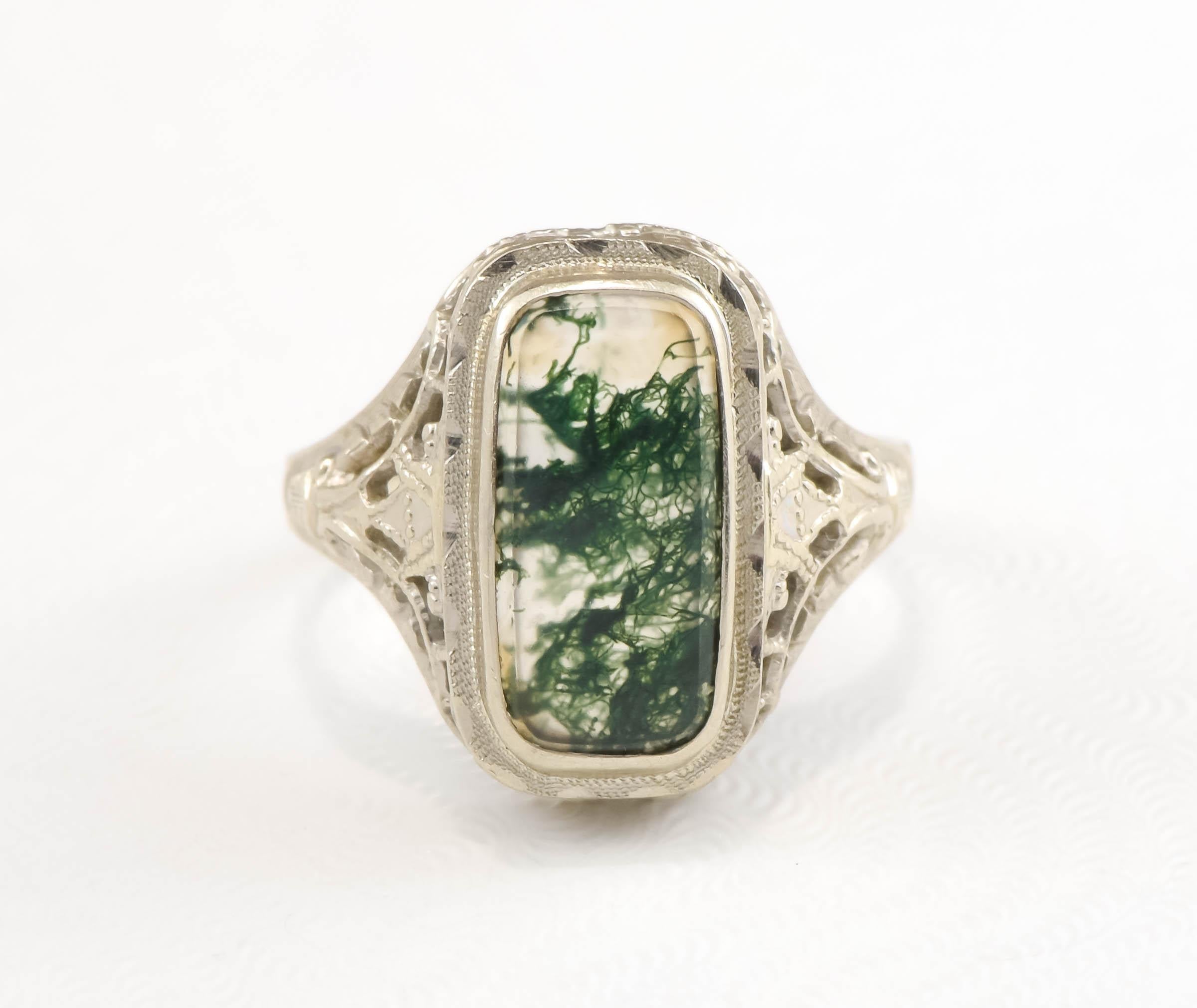 I'm pleased to offer a very charming, dainty Art Deco period Moss Agate filigree ring. (PLEASE NOTE: when this lovely ring is worn the agate looks much darker. Please see the photos on the hand)

Crafted of 14K white gold (marked and tested) the
