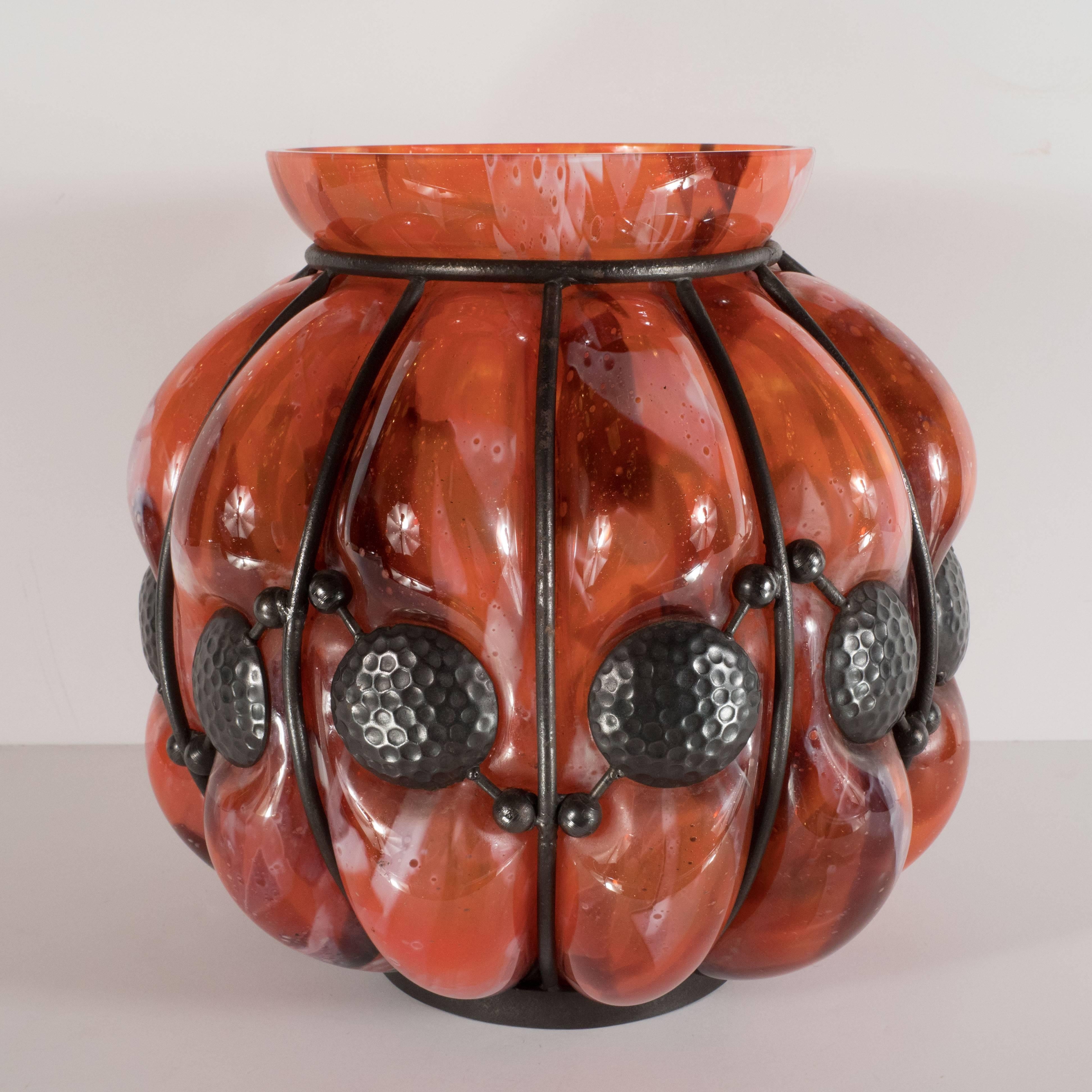 This rare and unique glass vase was handblown by Majorelle & Daum- one of the most renowned glass studios of the period- in France, circa 1930. Realized in mottled Vermillion glass-with hints of crimson and cream- the piece exhibits a subtle