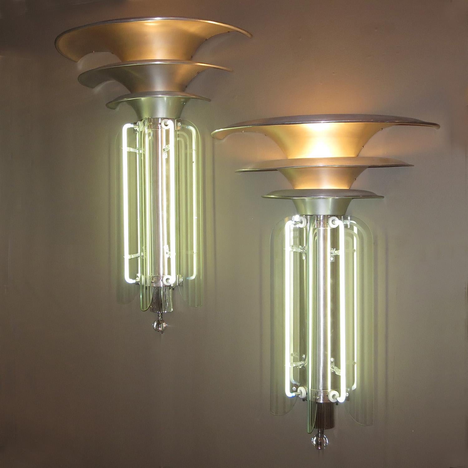 These wonderful sconces were originally from a Chicago area 1930s theatre. They utilized the most modern of materials and design, including bands of etched glass intersected with neon tubes. We have done a sensitive restoration to the lamps. The