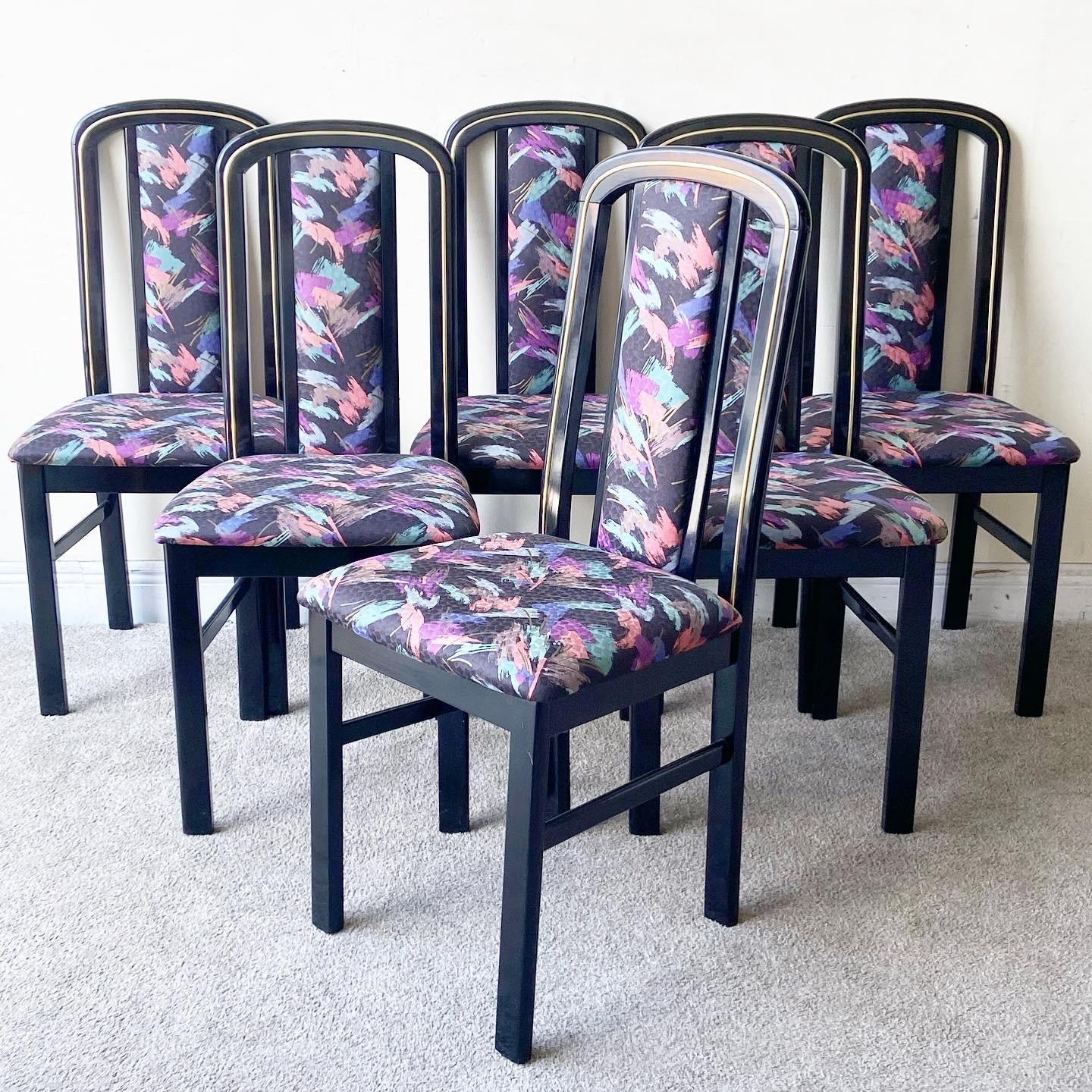 Incredible set of 6 deco/postmodern dining chairs. Each chair has a black lacquered wooden frame and features a blue, purple, pink and green fabric.