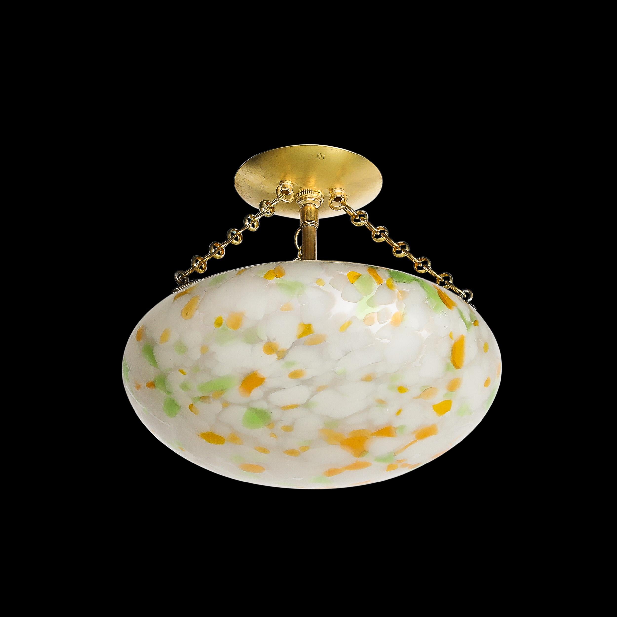 This charming and unique Art Deco Multicolor White Glass Pendant Chandelier W/Brass Fittings originates from France, Circa 1930. Features a rounded shade with a unique array of dashed opaque glass dots in opaque white, orange, and muted green. A