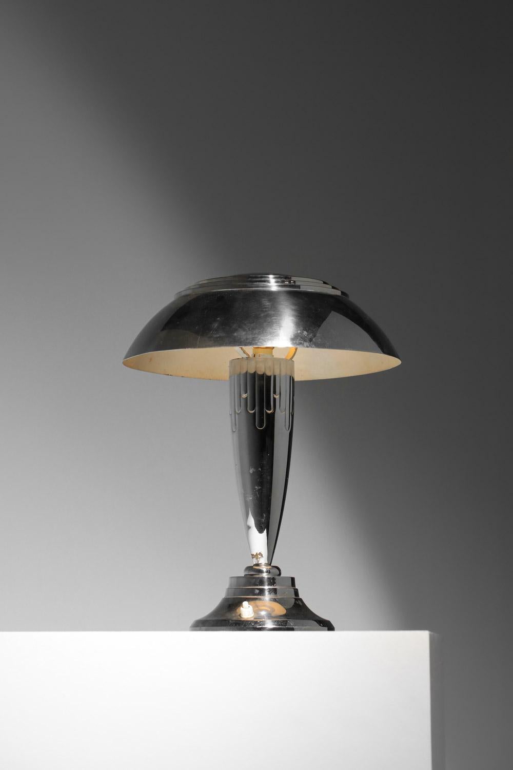 Bonita lámpara de mesa art decó de los años 50. Base y pantalla de metal cromado. 
Atractiva decoración geométrica en la base de la lámpara. 
Bonito estado vintage, con ligeras huellas de la edad y el uso (ver fotos). Sistema eléctrico original.
